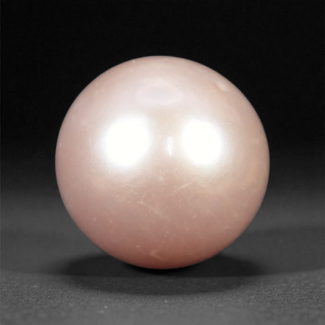 8.74 Carats Pink Cultured Freshwater Pearl - High-Luster Round - 10.6mm, 82XA: This elegant cultured freshwater pearl showcases a soft, natural pink tone with excellent surface luster and a refined spherical shape. Its high-gloss finish reflects light smoothly across the surface