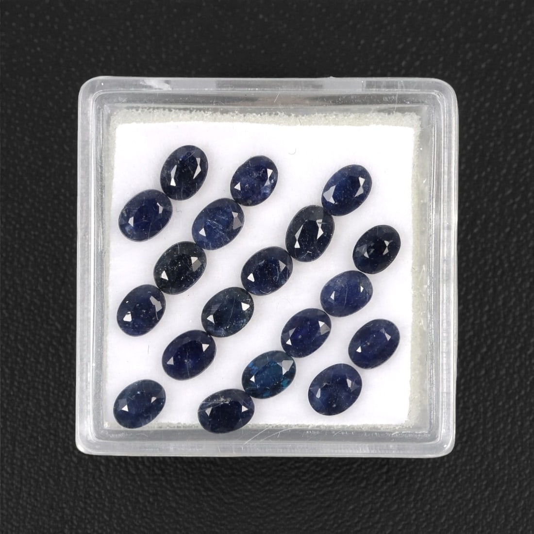 4.88 Carats Australian Blue Sapphire Parcel - Oval Cut, 95DA: This curated parcel of oval-cut blue sapphires from Australia exhibits a rich, deep blue hue, reminiscent of the ocean at midnight. Each stone is precision-cut to maximize light return, creating a spa