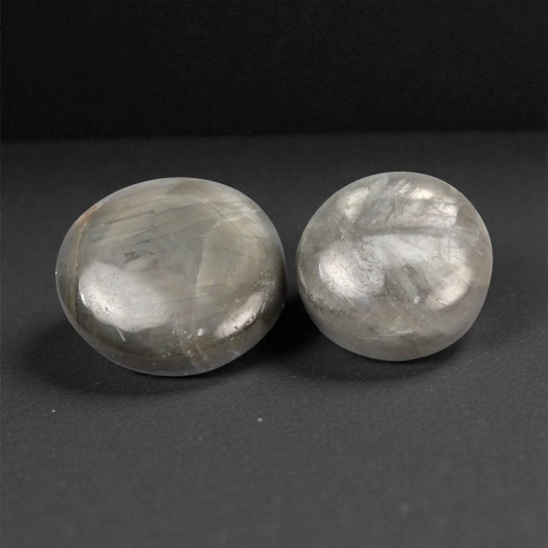 4.61 Carats Grey Star Sapphire Selection - Natural Burmese Stones, 306A: This curated selection of two cabochon-cut star sapphires from Burma captivates with a cool, silvery-grey hue, reminiscent of mist-shrouded mountain peaks and overcast skies. Each smooth, domed stone