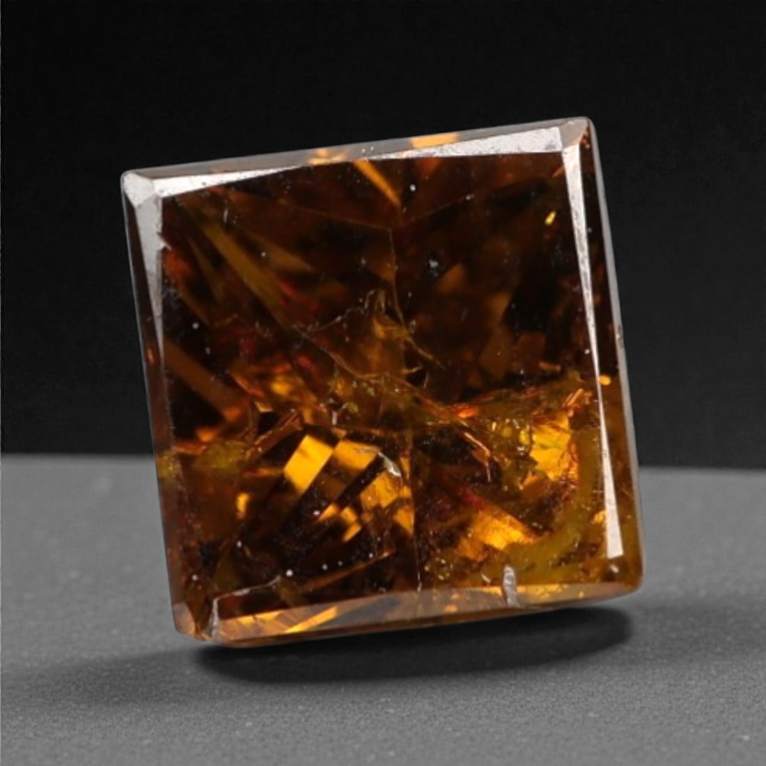 0.24 Carats Orangy Red Fancy Diamond - Princess Cut, 193A: This rare fancy orangy red diamond captivates with a vivid, warm hue that evokes the intensity of a glowing ember and the richness of a sunset. Cut in a well-proportioned princess shape, the stone's f