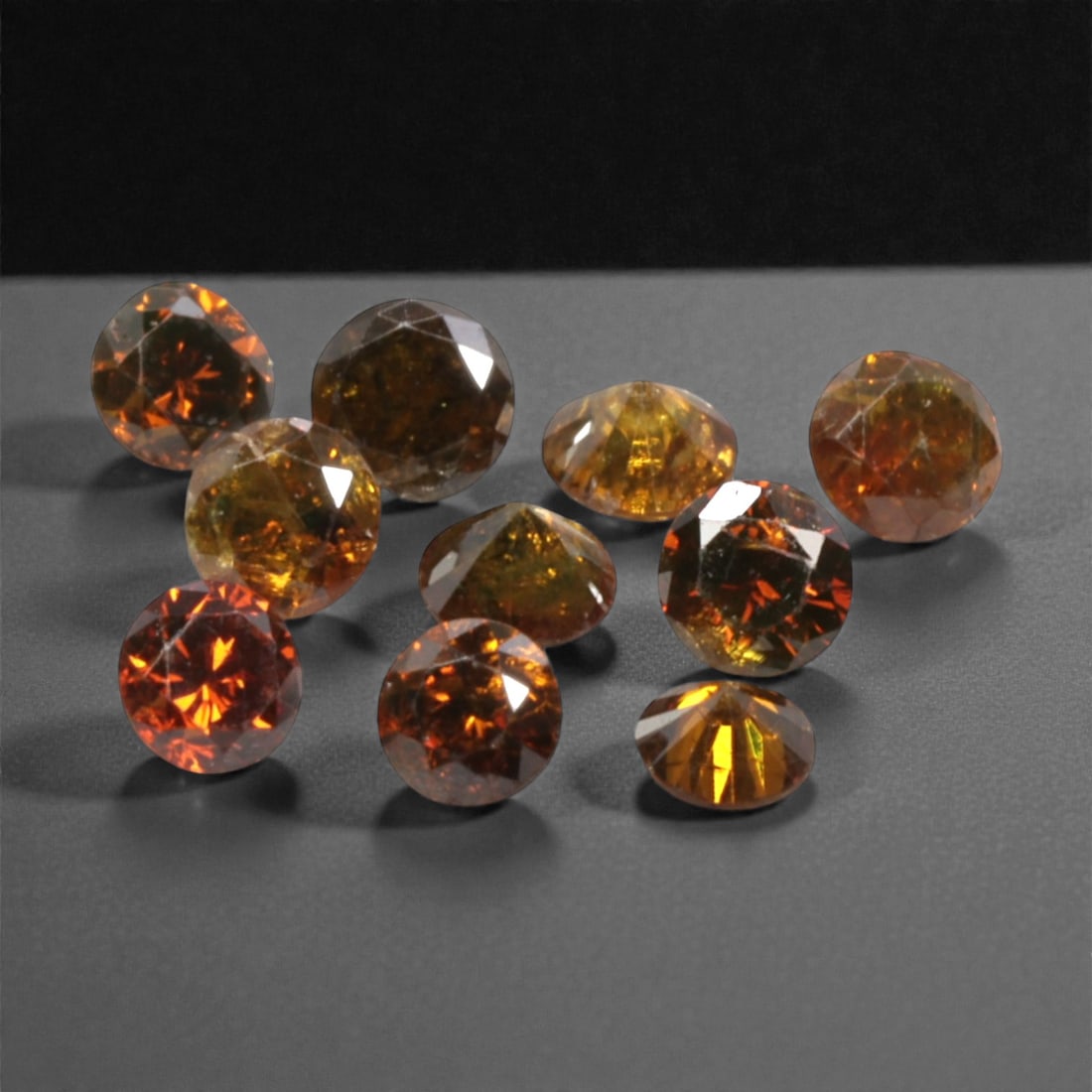 10 Pieces Irradiated Red Diamond Parcel - Round Brilliant Cut, 1.6-1.7mm, 279A: This vibrant parcel of 10 loose irradiated red diamond gems captivates with a rich, fiery red hue that evokes the intensity of a glowing ember and the warmth of a sunset. Each stone is cut in a well-p