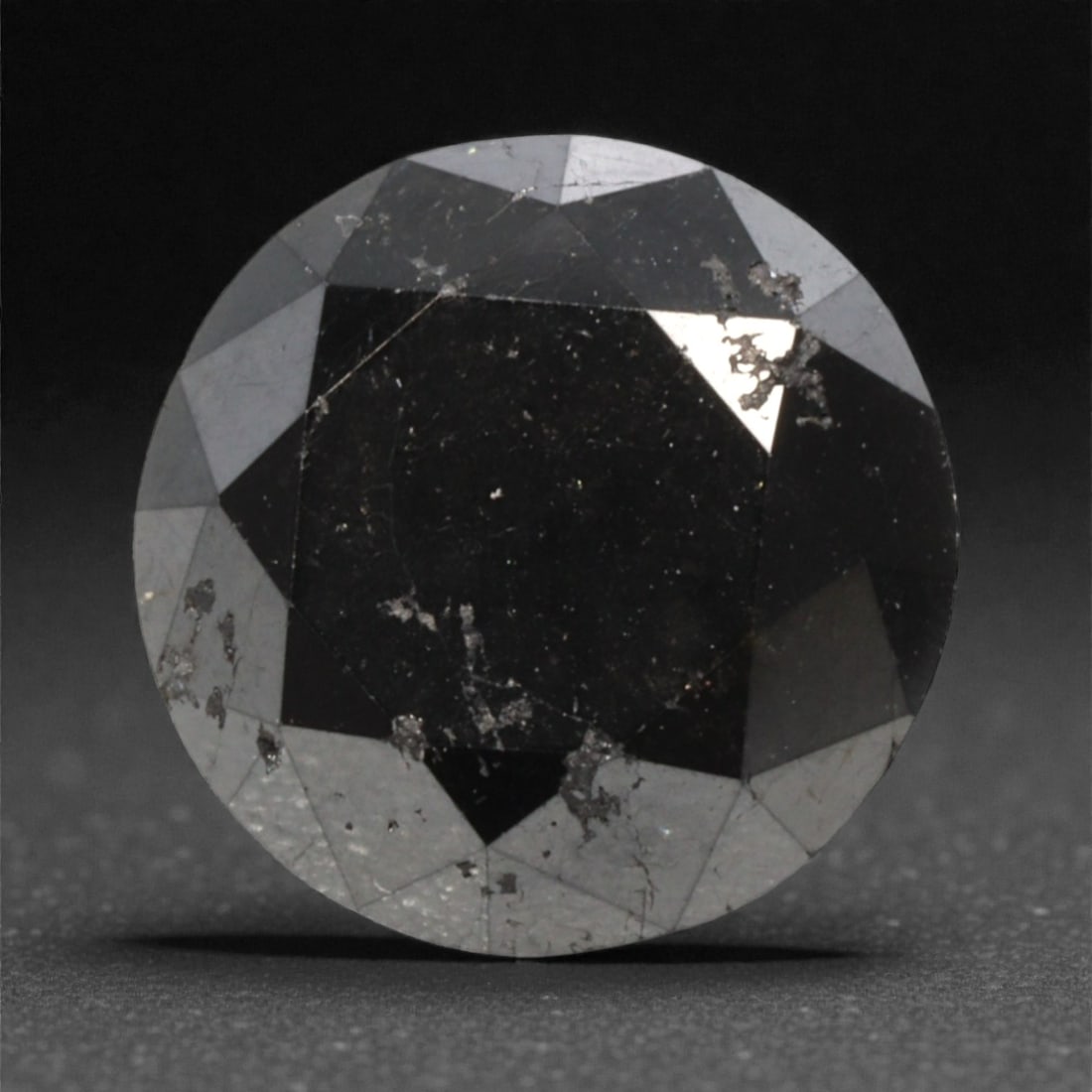 2.09 Carats Black Diamond - Round Brilliant Cut, 281A: This substantial black diamond captivates with a deep, opaque black hue that evokes the intensity of polished obsidian and the mystery of a midnight sky. Cut in a well-proportioned round brilliant sha