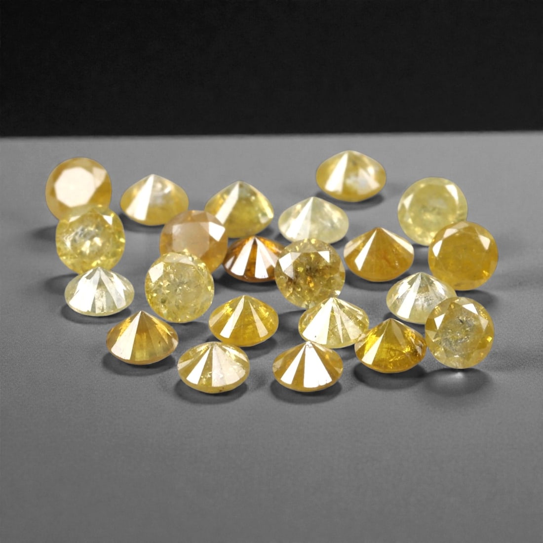 1.06 Carats Fancy Yellow Diamond Parcel - Natural African Stones, 53A: This exquisite parcel of round fancy diamonds radiates with a warm, honeyed glow, ranging from soft lemon and buttercup hues to deeper golden amber tones. Each stone is precision-cut to maximize light