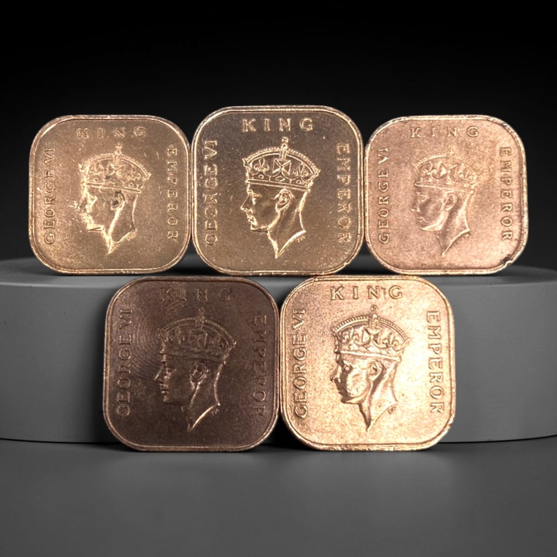 MALAYA: Colonial Legacy - 5-Piece King George VI 1 Cent Square Coin Set, 1939-1945, 20mm, 27ZJ: This 5-piece set of square 1 Cent coins from Malaya, minted between 1939 and 1945, encapsulates the final years of British colonial rule in Southeast Asia during World War II. Each 20mm piece features