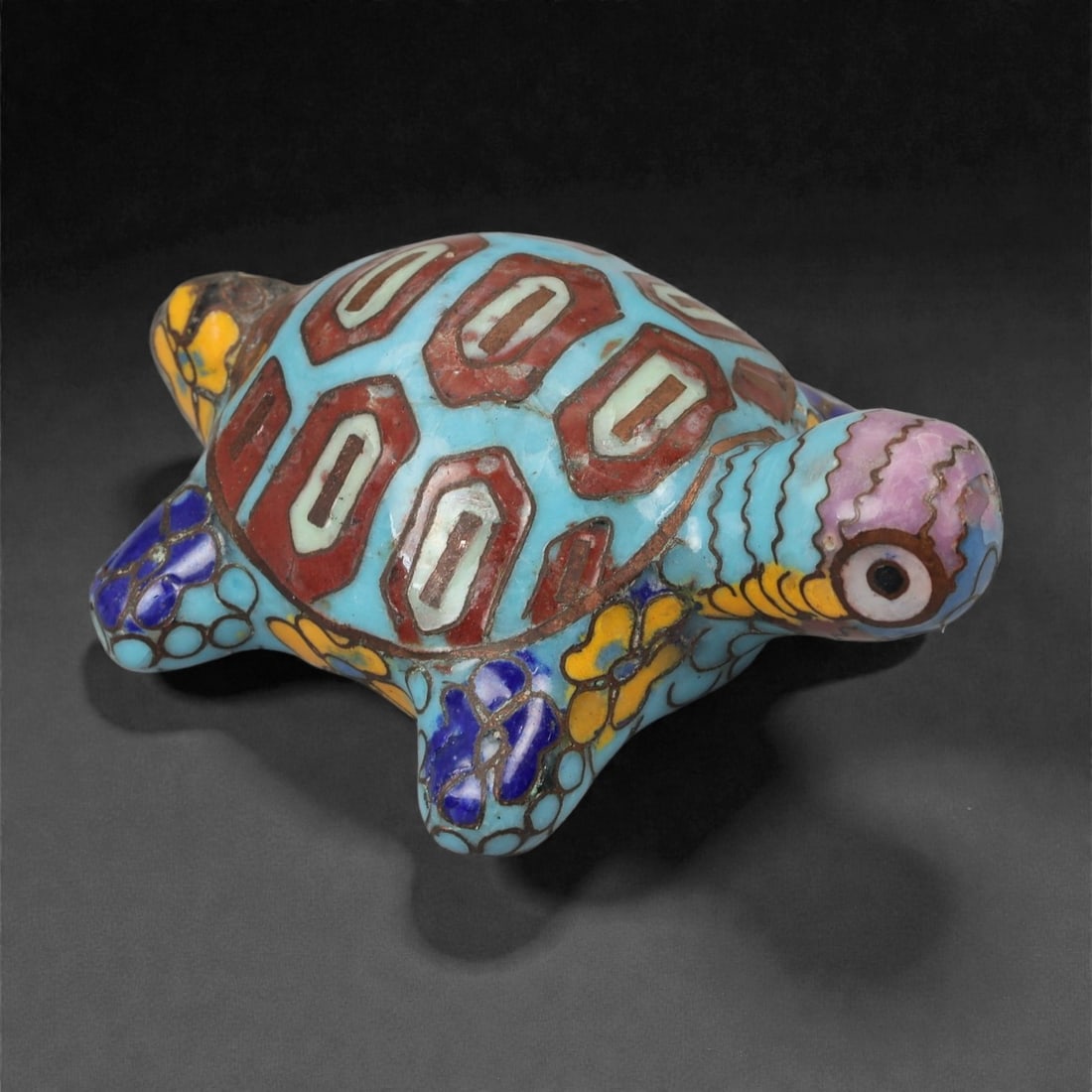 A Chinese Cloisonne Enamel Tortoise Effigy, 20th Century, 6FH: Modeled as a recumbent tortoise with the head extended forward and limbs splayed to either side, the effigy is constructed over a metal core and decorated overall with cloisonne enamel on a turquoise-