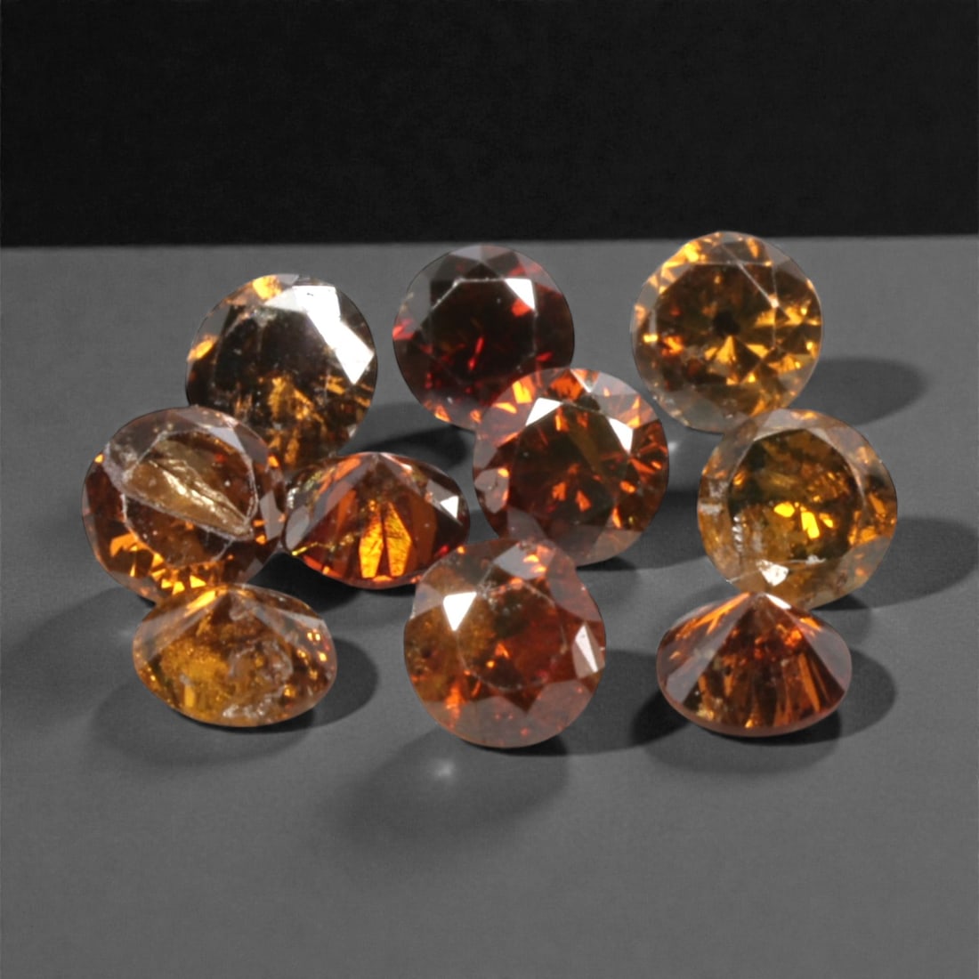 10 Pieces Irradiated Red Diamond Parcel - Round Brilliant Cut, 1.6-1.7mm, 276A: This vibrant parcel of 10 loose irradiated red diamond gems captivates with a rich, fiery red hue that evokes the intensity of a glowing ember and the warmth of a sunset. Each stone is cut in a well-p