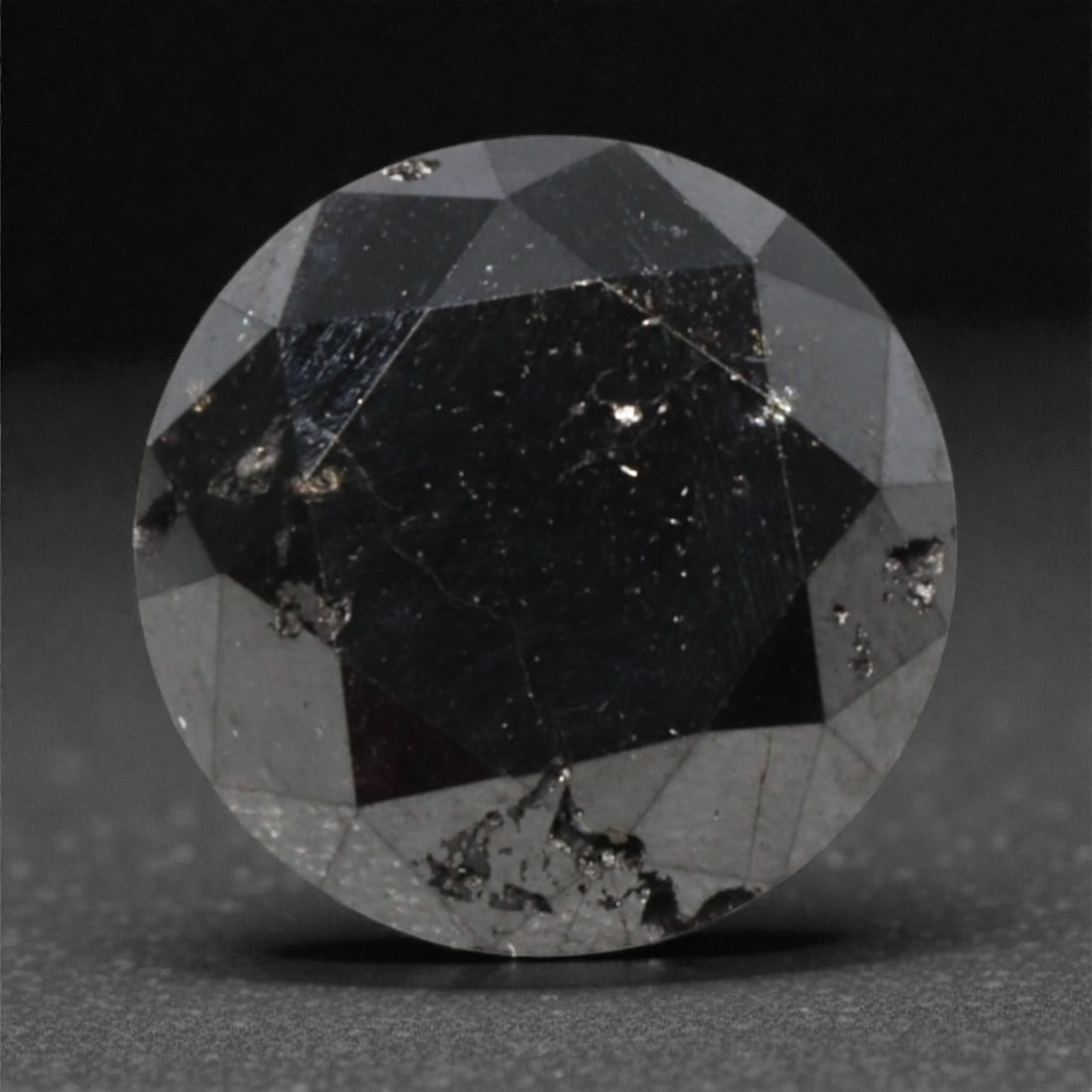 1.17 Carats Black Diamond - Round Brilliant Cut, 292A: This substantial black diamond captivates with a deep, opaque black hue that evokes the intensity of polished obsidian and the mystery of a midnight sky. Cut in a well-proportioned round brilliant sha