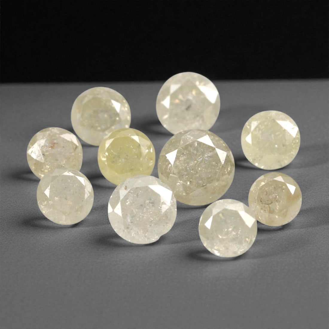 1.01 Carats Fancy Yellow Diamond Parcel - Natural African Stones, 41A: This exquisite parcel of round fancy diamonds radiates with a warm, honeyed glow, ranging from soft lemon and buttercup hues to deeper golden amber tones. Each stone is precision-cut to maximize light