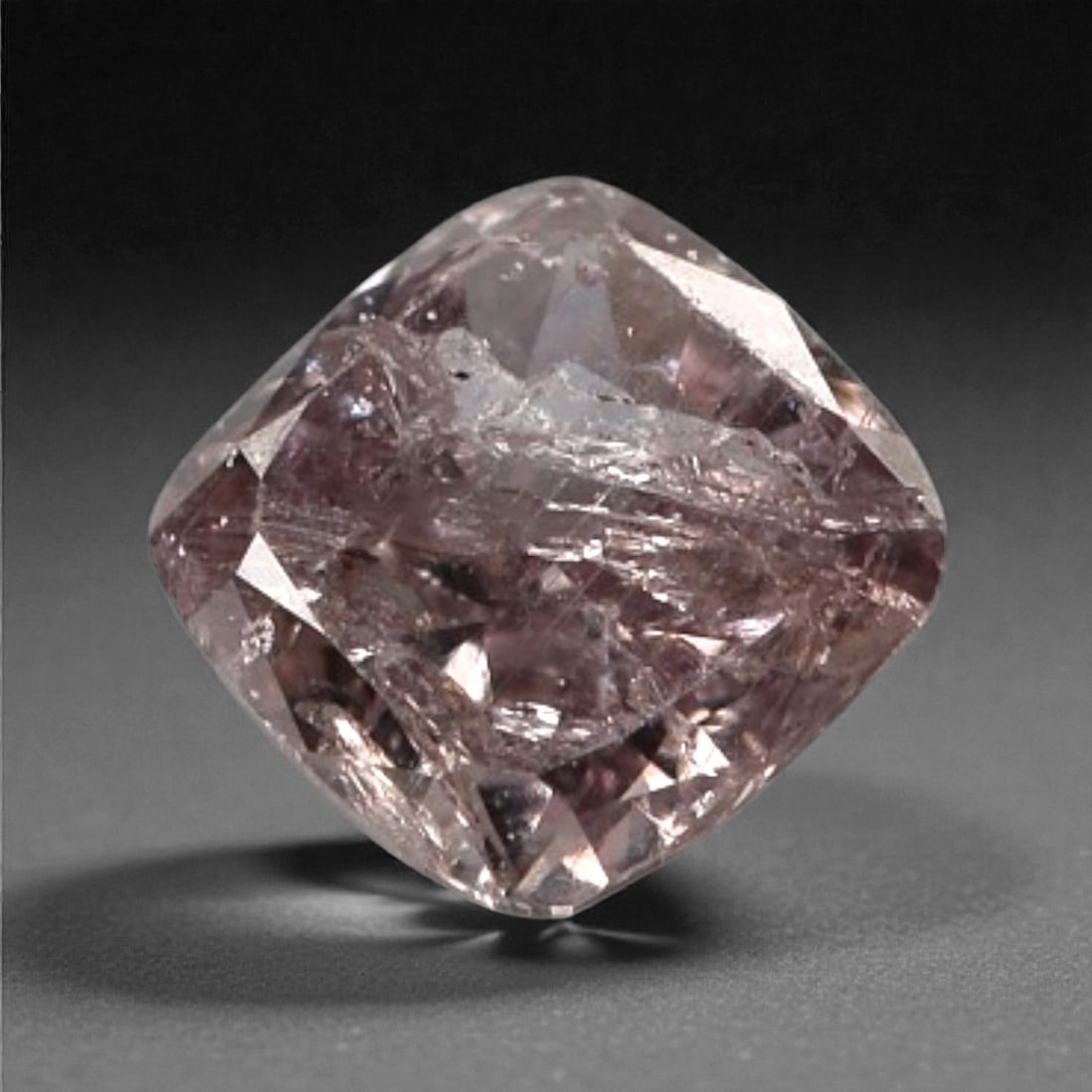 0.10 Carats Purplish Pink Diamond - Natural Argyle Mine, Australia, 87A: This singular purplish pink diamond from the Argyle mine is a rare and captivating gem, showcasing the distinctive, velvety hue that has made Australian pink diamonds among the most coveted in the wor