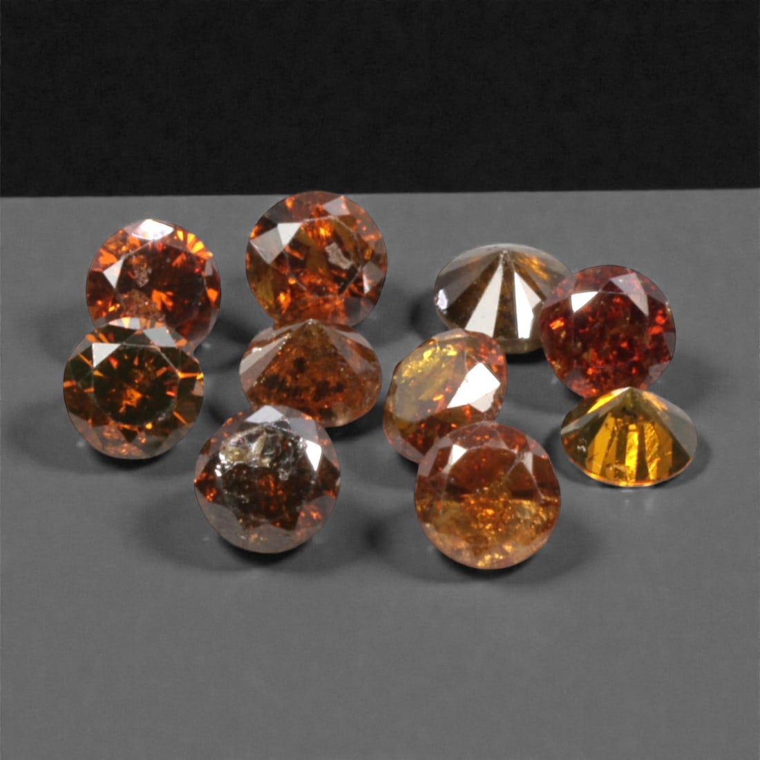 10 Pieces Irradiated Red Diamond Parcel - Round Brilliant Cut, 1.6-1.7mm, 280A: This vibrant parcel of 10 loose irradiated red diamond gems captivates with a rich, fiery red hue that evokes the intensity of a glowing ember and the warmth of a sunset. Each stone is cut in a well-p