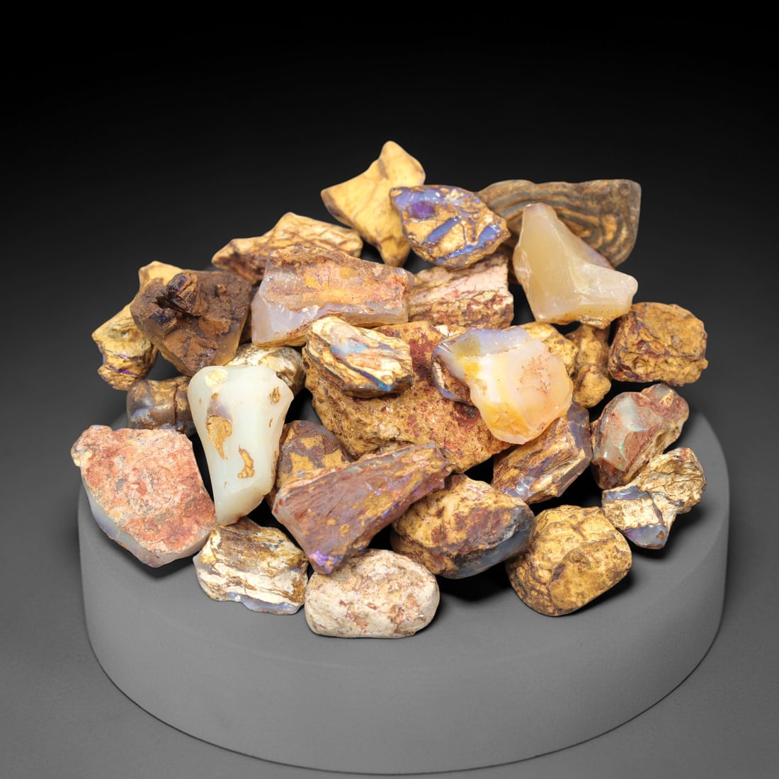 A Lot of Boulder Opal Rough Specimens, 60ZJ: This lot consists of multiple boulder opal rough specimens, with individual sizes ranging from 1 to 2.8 cm and a total weight of 45.73 grams. Each specimen retains its natural ironstone host rock matr