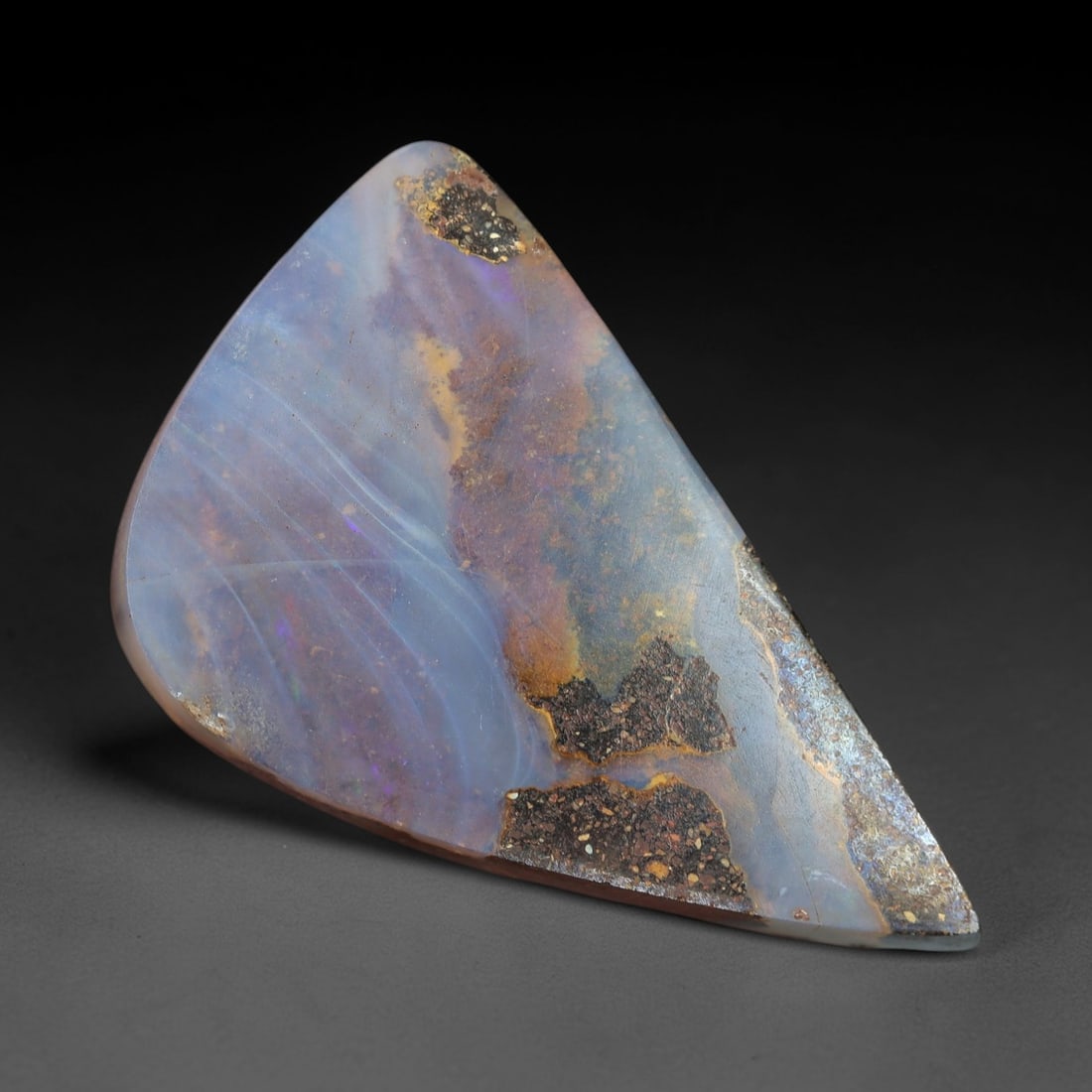 14.83ct Boulder Opal Cabochon - Soft Pastel Play-of-Color Specimen, 44XM: This 14.83ct boulder opal cabochon, measuring 24x16mm, is a striking example of Australia's iconic gemstone, showcasing the delicate beauty of nature's artistry. The freeform triangular cabochon is po