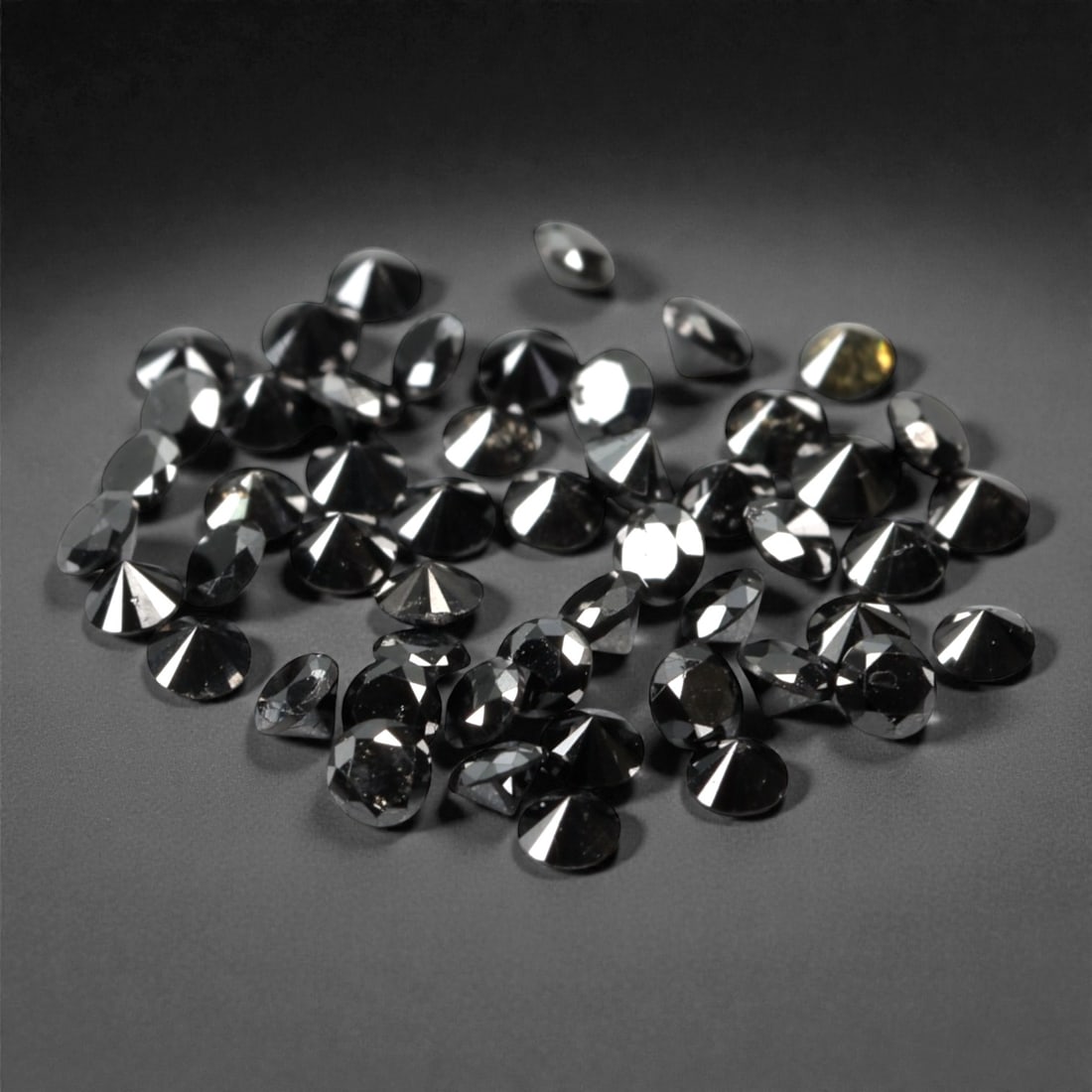 50 Pieces Black Diamond Parcel - Round Brilliant Cut, 1.7mm, 166A: This versatile parcel of 50 loose black diamond gems captivates with a deep, opaque black hue that evokes the intensity of polished obsidian and the mystery of a midnight sky. Each stone is cut in a w