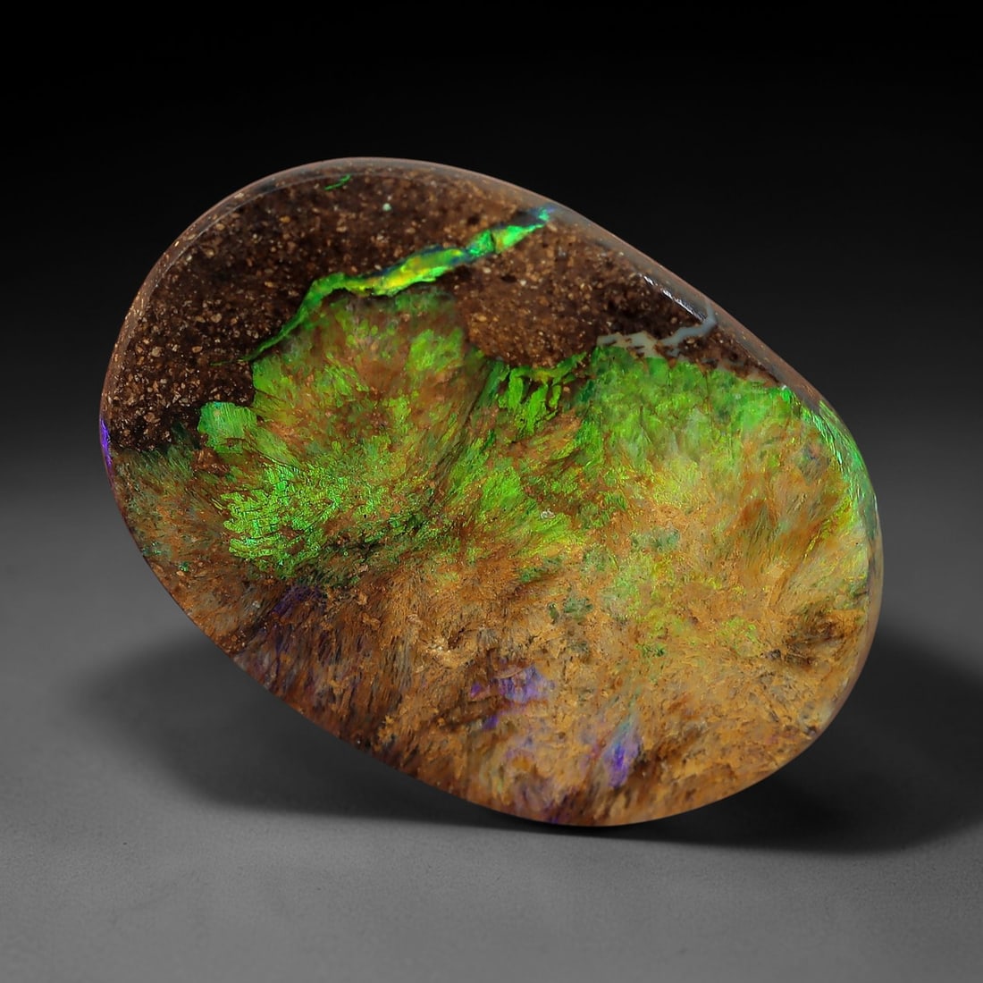 2.75 Carats Green and Gold Iridescent Yowah Opal Cabochon - Natural Australian Stone, 22XM: This exceptional Yowah opal cabochon features a dynamic, organic pattern of vibrant green and golden iridescence, set against a rich, earthy brown ironstone matrix. The stone's oval form showcases a s