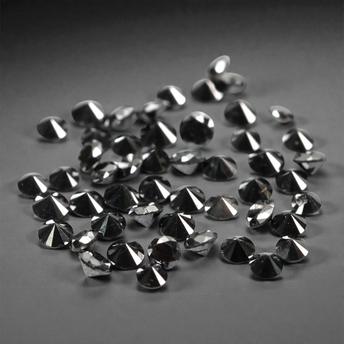 50 Pieces Black Diamond Parcel - Round Brilliant Cut, 1.7mm, 174A: This versatile parcel of 50 loose black diamond gems captivates with a deep, opaque black hue that evokes the intensity of polished obsidian and the mystery of a midnight sky. Each stone is cut in a w