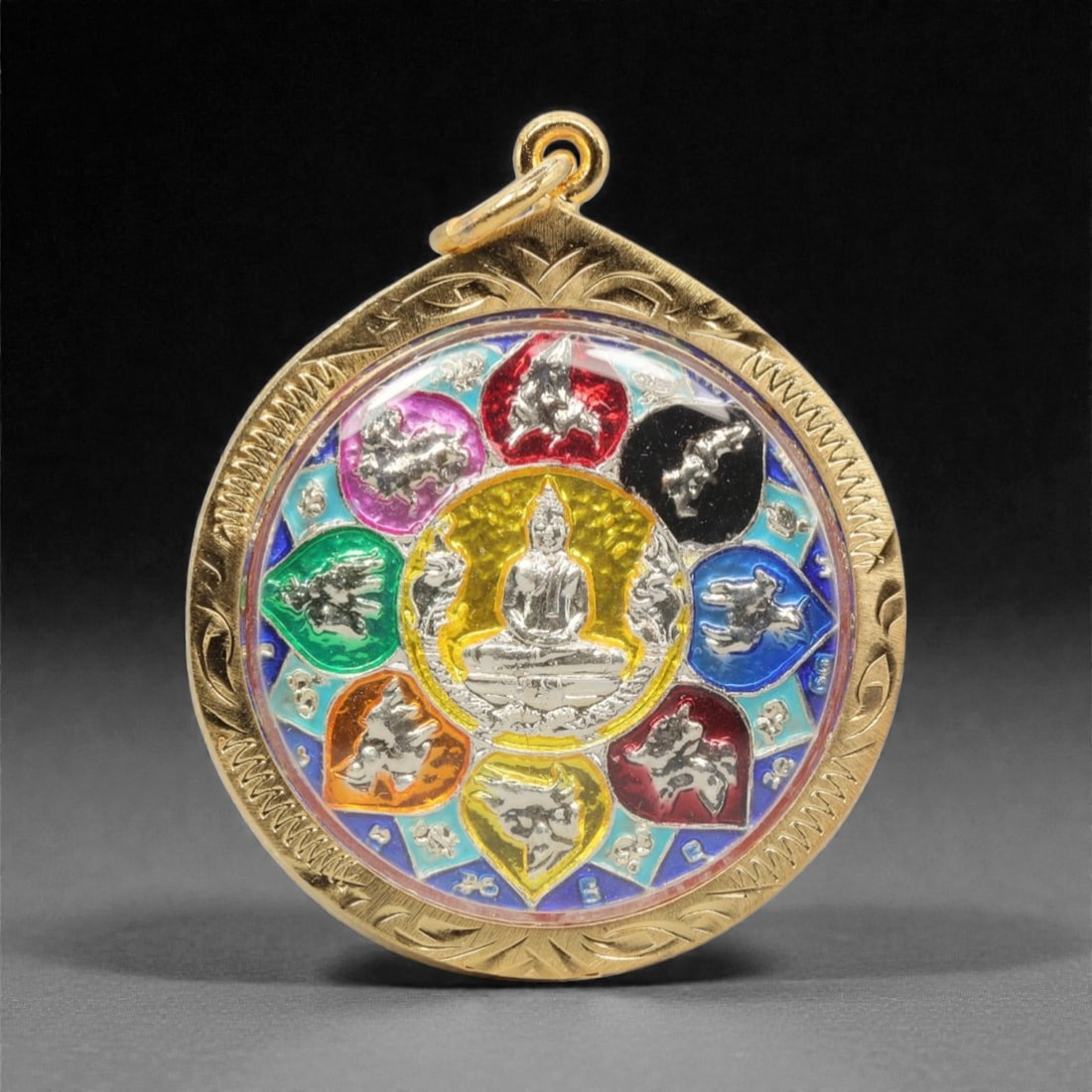 A Thai Enameled Metal Zodiac Amulet in Gilt Metal Case, 20th Century, 100FN: Cast from silver-toned metal with polychrome enamel, the amulet depicts a seated Buddha at its center, encircled by eight silver animal figures set within colored enameled petal-shaped compartments, w