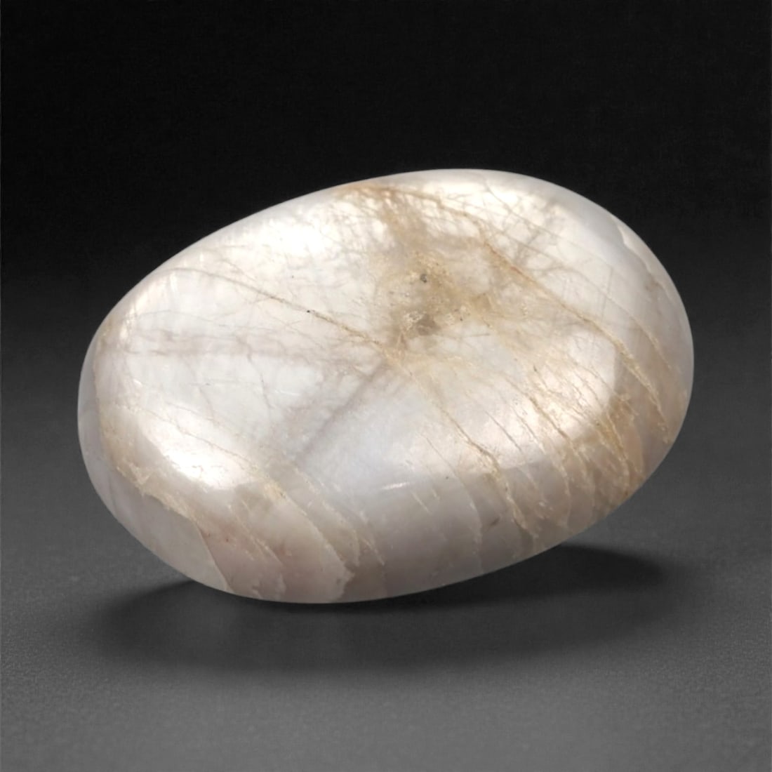 6.67 Carats Trapiche Sapphire Cabochon - Natural Burmese Stone, 330A: This exceptional oval cabochon-cut trapiche sapphire from Burma exhibits a soft, milky pale grayish-white hue, reminiscent of mist over a mountain stream. The stone is characterized by its natural tra