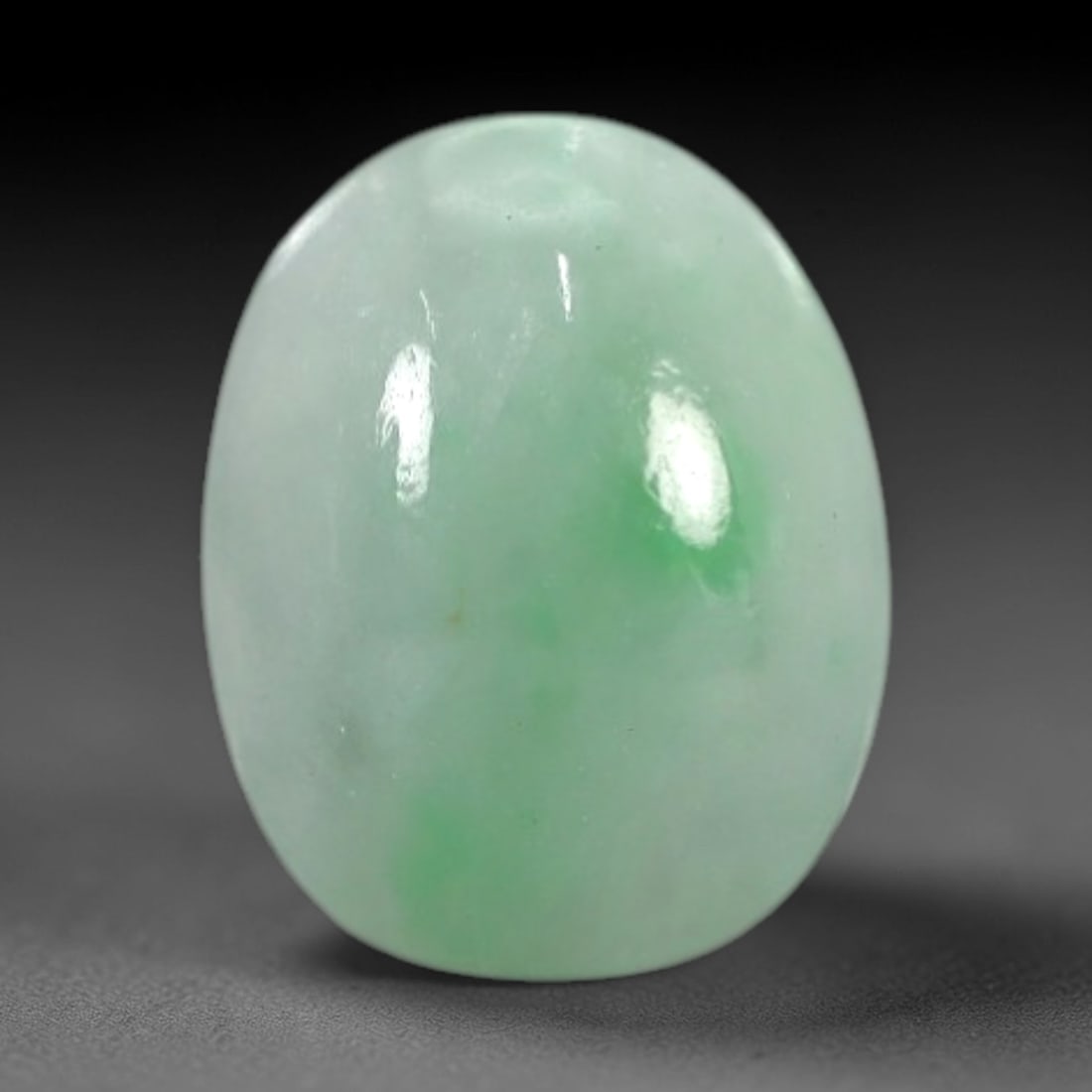 2.25 Carats Apple Green Burmese Jadeite Jade Cabochon - Natural Loose Gemstone, 32XN: This singular Burmese jadeite jade cabochon presents a luminous apple green hue, soft and luminous with a translucent quality that allows light to filter gently through its smooth, domed surface. The