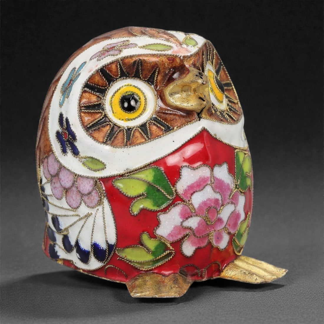 A Chinese Cloisonne Enamel Owl Effigy, 20th Century, 93FG: Modeled as a stylized owl standing upright on short feet, the effigy is constructed over a metal core and decorated overall with cloisonne enamel on a white and red ground, the surface densely ornamen