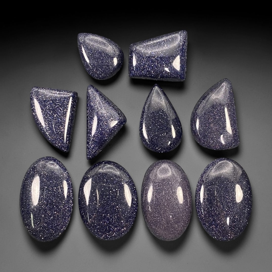 171.34 Carats Midnight Blue Goldstone Cabochon Selection 1.6-2.8cm, 71ZJ: This dynamic selection of midnight blue goldstone cabochons dazzles with a cosmic, starry sparkle that defines the stone's iconic allure. Set against a deep, velvety indigo base, each piece is densely