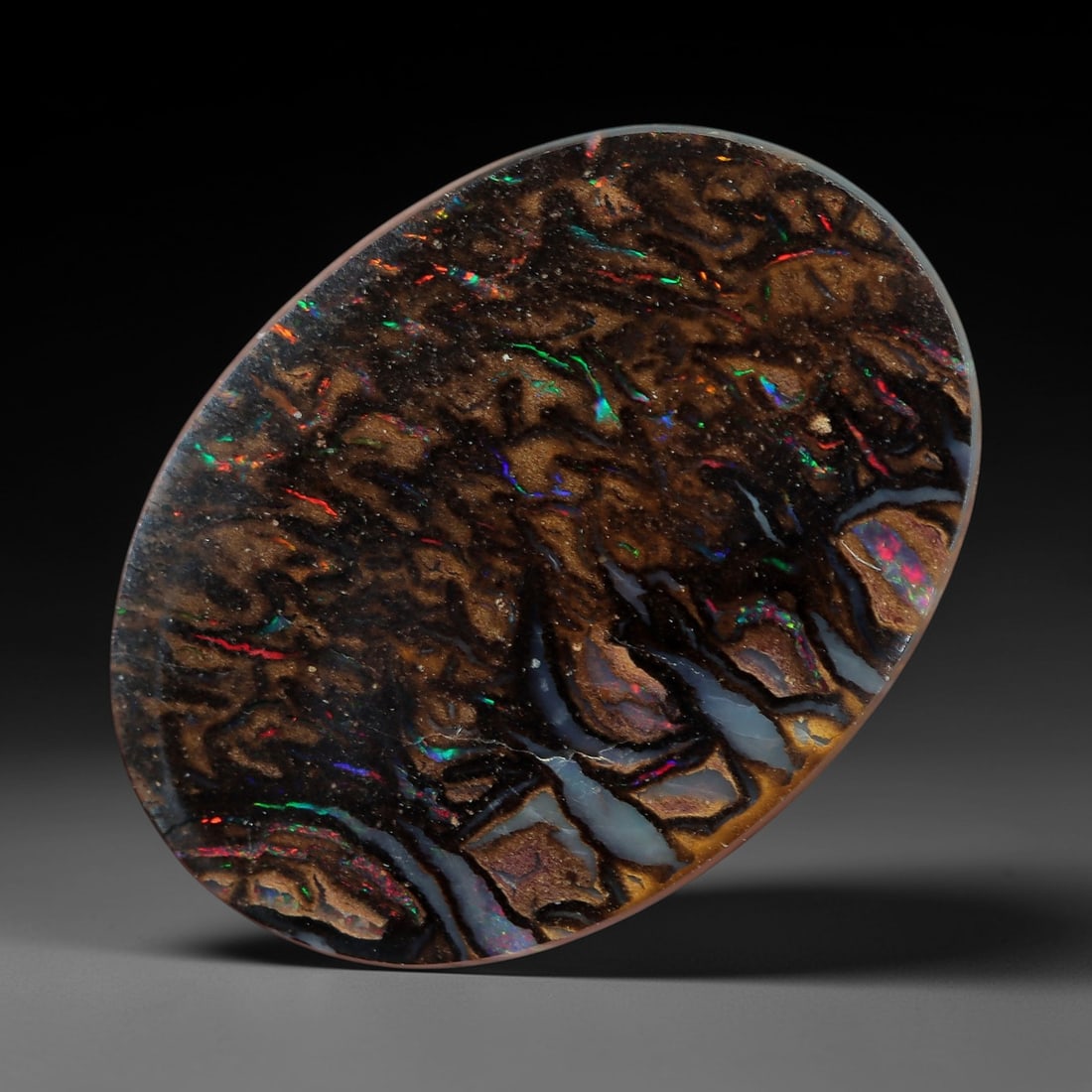 3.49 Carats Koroit Boulder Opal Cabochon - Natural Australian Stones 13.4x10mm, 14XM: This extraordinary 3.49-carat Koroit boulder opal cabochon is a natural masterpiece, showcasing a dense, intricate tapestry of multicolored play-of-color set within a rich, earthy ironstone matrix. Th