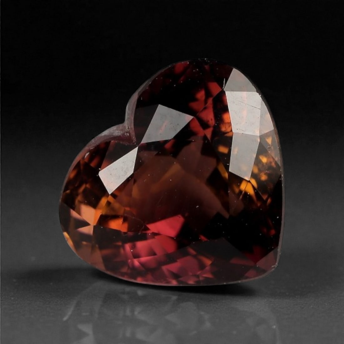 3.32 Carats Deep Red-Brown Tourmaline Gem - Natural Nigerian Stone, 9.8x8.7x6.2mm, 9XK: This richly saturated heart-shaped tourmaline exhibits a moody interplay of deep claret, burnt sienna, and ember red. The expertly faceted cut amplifies its internal fire, with warm flashes emerging f