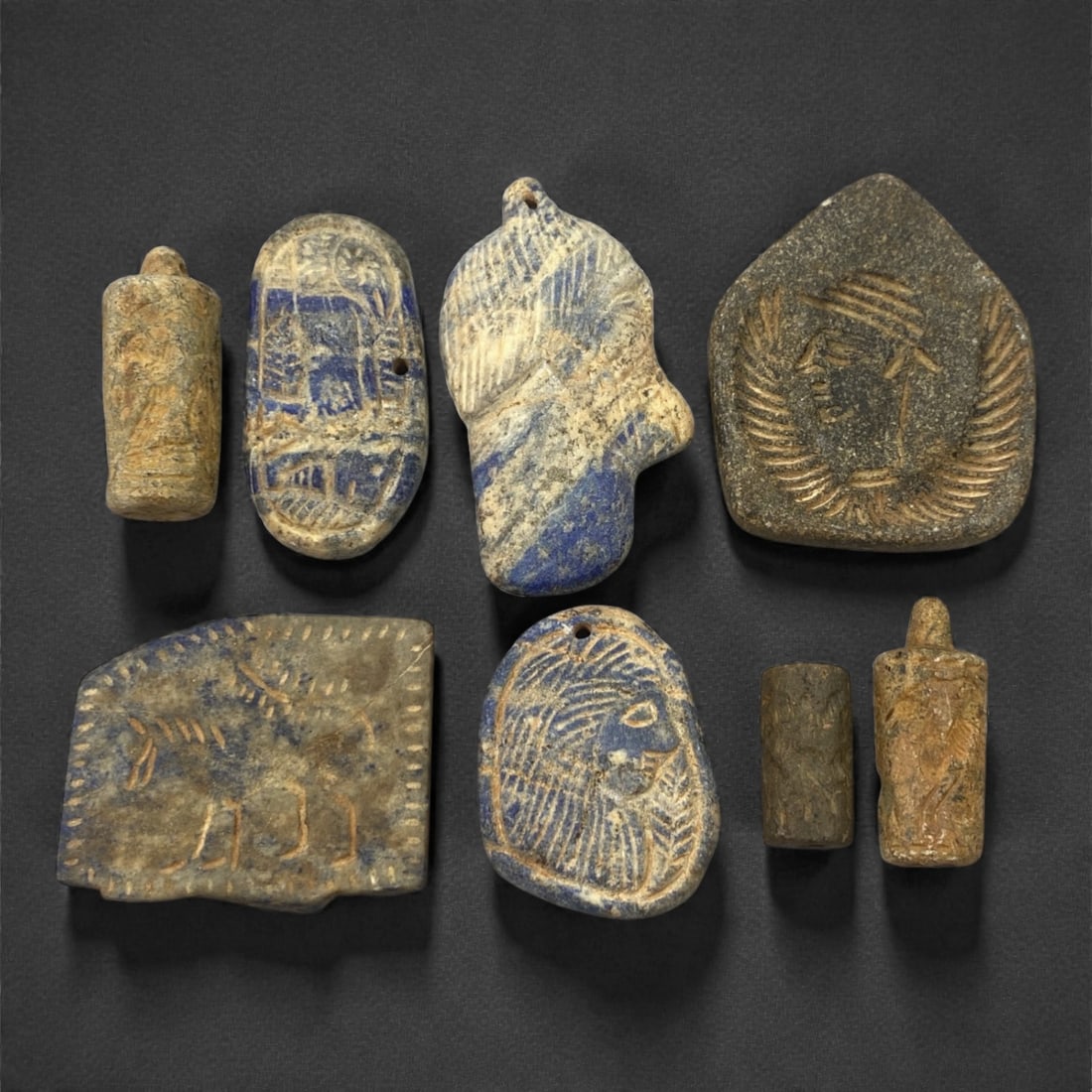 A Group of Near Eastern Lapis Lazuli and Schist Amulets and Cylinder Seals, 100FK (1 of 1)