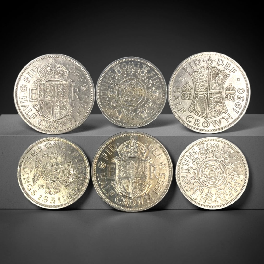 UNITED KINGDOM: Commonwealth - 6-Piece Silver Half Crown & Florin Set, 1950-1955, 28-32mm, 22ZJ: This 6-piece set of British silver coins, minted between 1950 and 1955, encapsulates the transition from the reign of King George VI to Queen Elizabeth II, and the enduring symbolism of the Commonweal
