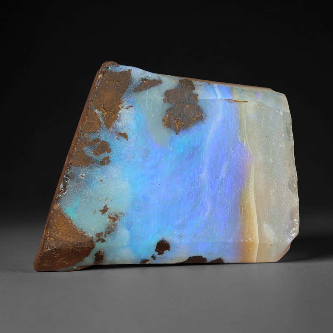 13.75 Carats Iridescent Blue Winton Opal Rough - Natural Australian Specimen 19x14mm, 89XM: This exceptional rough opal from Winton, Australia, captivates with a vivid play of color, where intense flashes of celestial blue and subtle turquoise swirl through a milky, translucent base. The nat