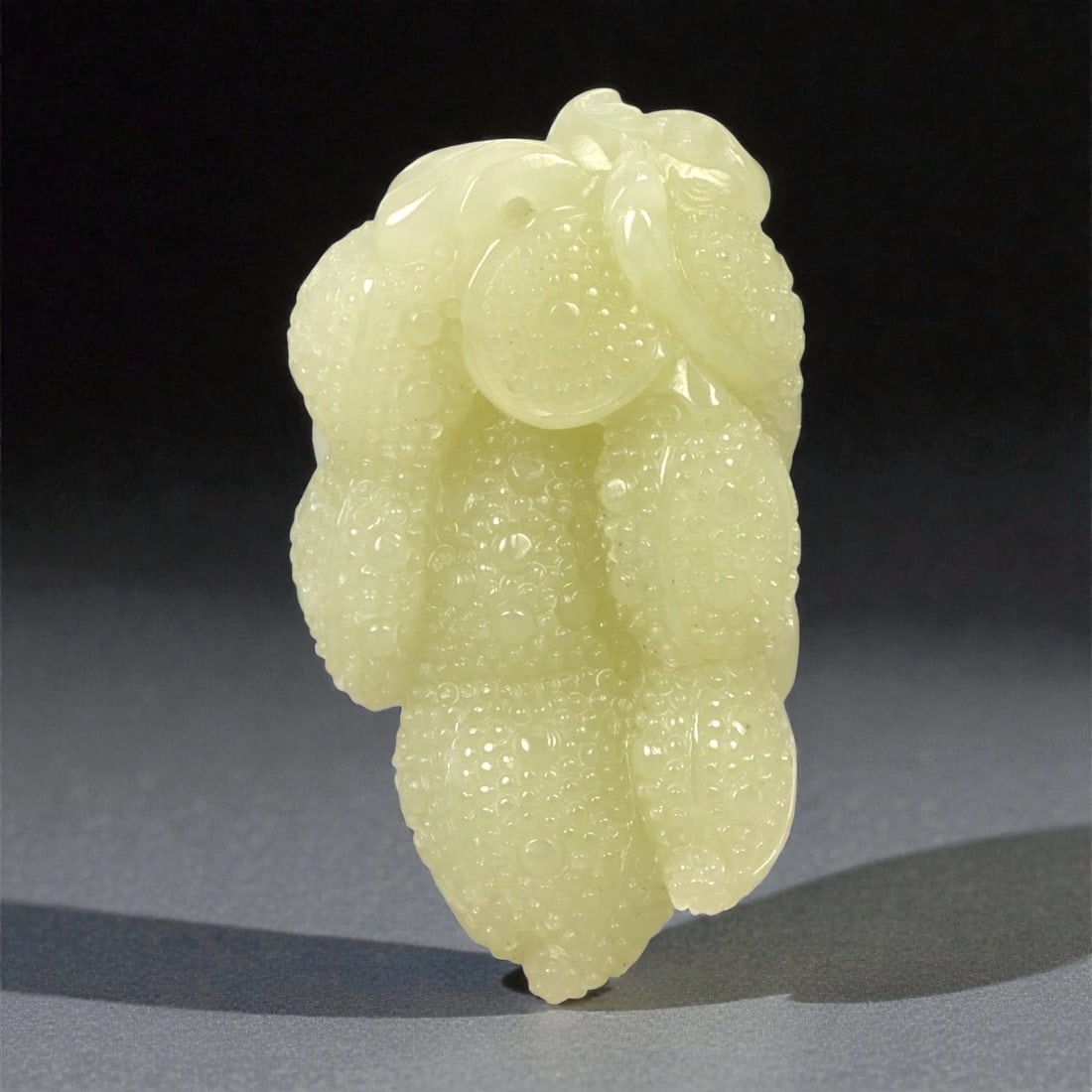 A Chinese Nephrite Jade Fruit Group, 20th Century, 79FA: Carved from pale green nephrite jade with translucent areas and fine natural inclusions, the object is modeled in the form of a clustered fruit group. The composition consists of overlapping lobed for