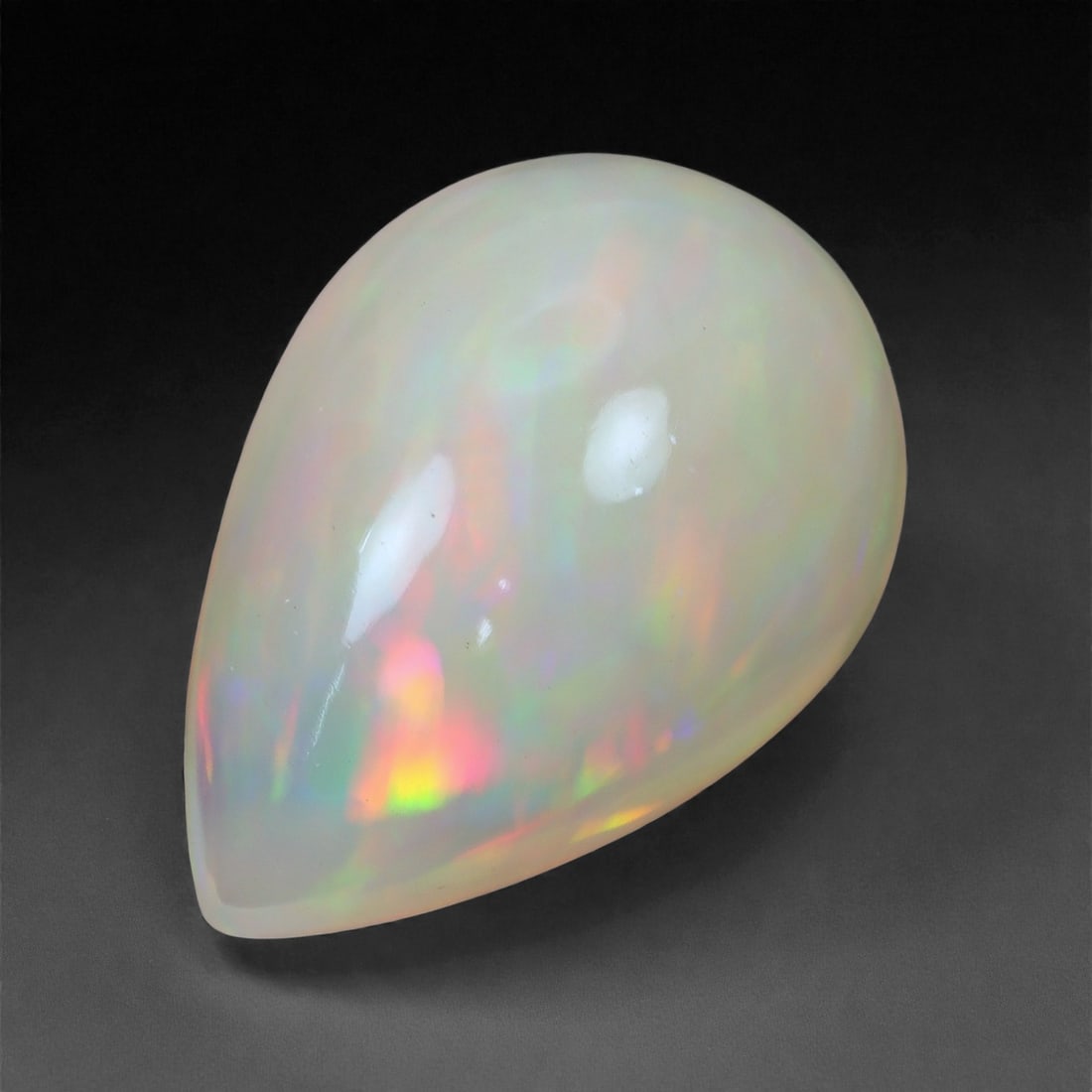 3.78 Carats Radiant Pastel Welo Opal - Natural Ethiopian Gemstone 14.3x10x6mm, 45XH: This opal dazzles with a delicate yet radiant display of color, featuring glints of rose-pink, lime green, and amber orange suspended in a luminous, milky body. The play-of-color flows smoothly across