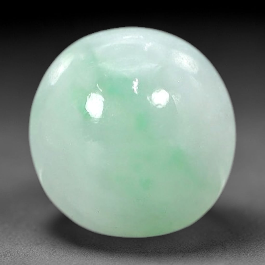 3.36 Carats Apple Green Burmese Jadeite Jade Cabochon - Natural Loose Gemstone, 50AC: This round Burmese jadeite jade cabochon displays a soft apple green hue, with delicate, concentrated patches of richer green that add depth to its milky translucency. The smooth, polished surface ref