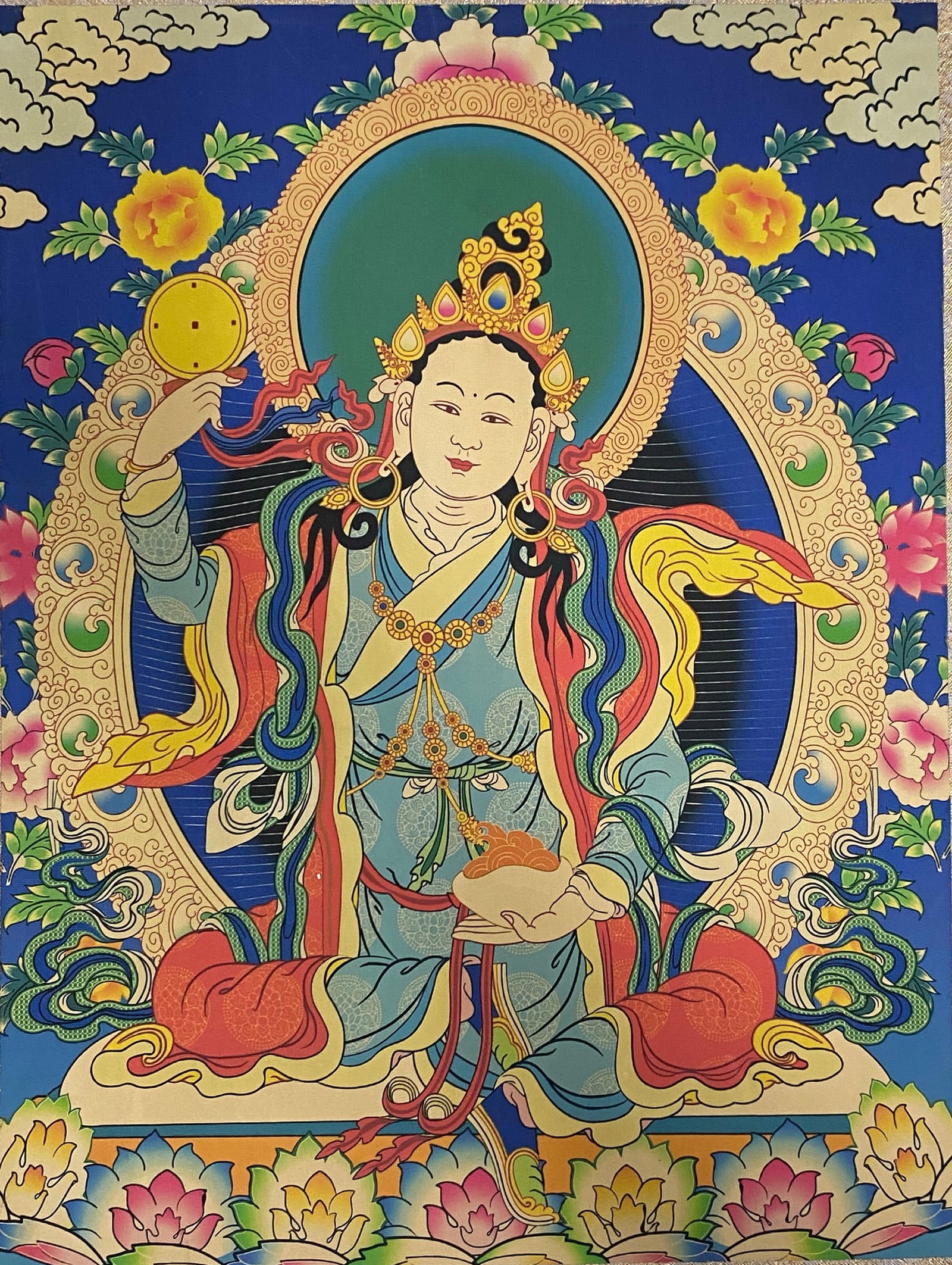 A Chinese Ink and Color Art Print, Buddhist Deity Thangka, 20th Century, 17FV: Printed on a deep blue ground, the composition depicts a seated Buddhist deity in the traditional thangka style. The figure is adorned with an ornate golden crown set with colored jewels, a beaded nec