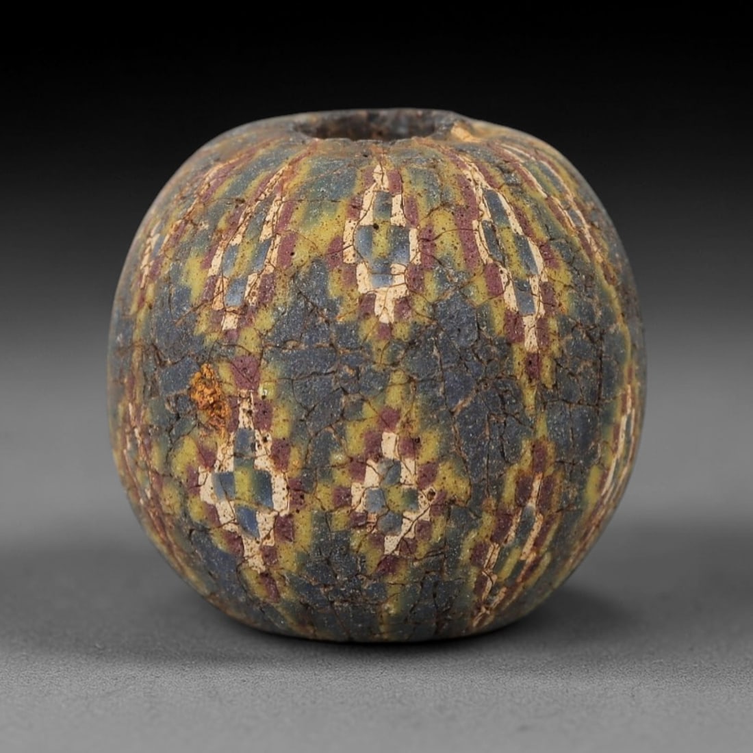 Ancient Glass Mosaic Bead - Roman Bead, 41ZM: This ancient bead is crafted from polychrome mosaic glass, formed using the millefiori technique characteristic of Roman glassworking traditions. The spherical form features a repeating geometric patt