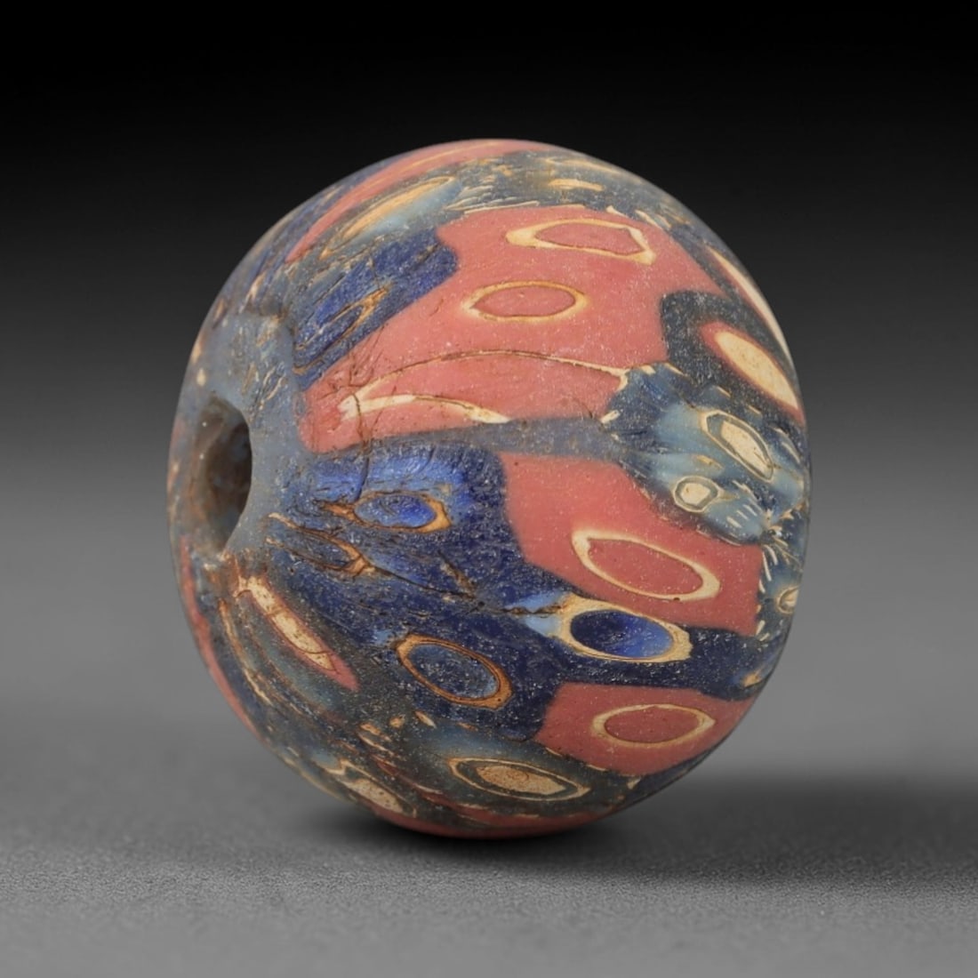 Exceptional Ancient Glass Eye Bead - Egyptian Royal Amulet Bead, 35ZM: This remarkable bead, measuring a substantial 2.2 cm (0.87 in), is a masterwork of Egyptian polychrome glass craftsmanship, utilizing the sophisticated core-formed and trailed techniques. Its spherica