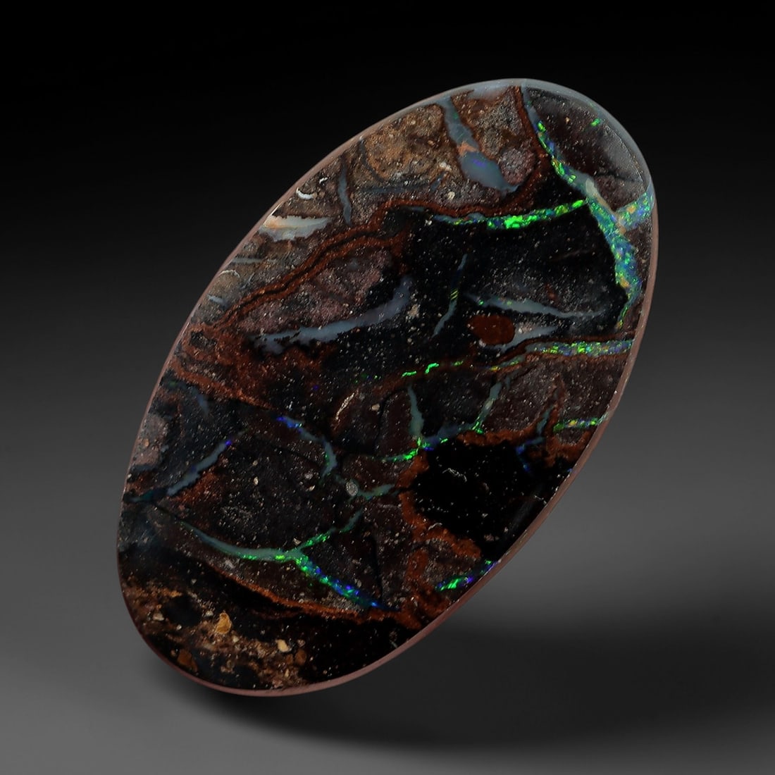 2.55 Carats Koroit Boulder Opal Cabochon - Natural Australian Stones 11.8x6.8mm, 9XM: This striking 2.55-carat Koroit boulder opal cabochon is a natural geological masterpiece, featuring vivid veins of iridescent play-of-color that snake through a rich, dark ironstone matrix. The elong
