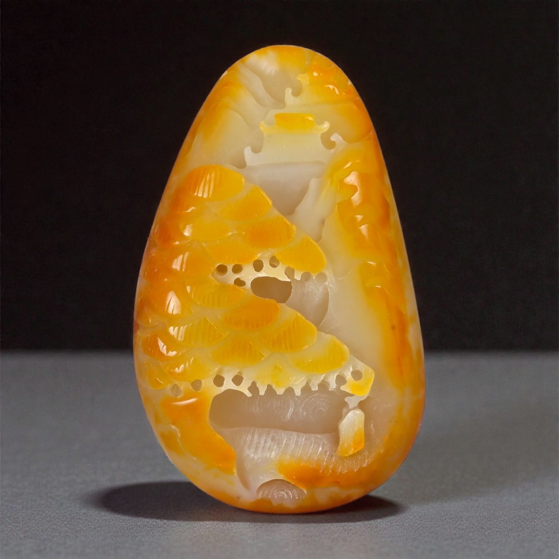 A Chinese Nephrite Jade Landscape Plaque, 20th Century, 24FA: Carved from pale cream-colored nephrite jade with extensive areas of amber and russet skin, the plaque is worked in relief and partial openwork depicting a stylized landscape composition. The design i