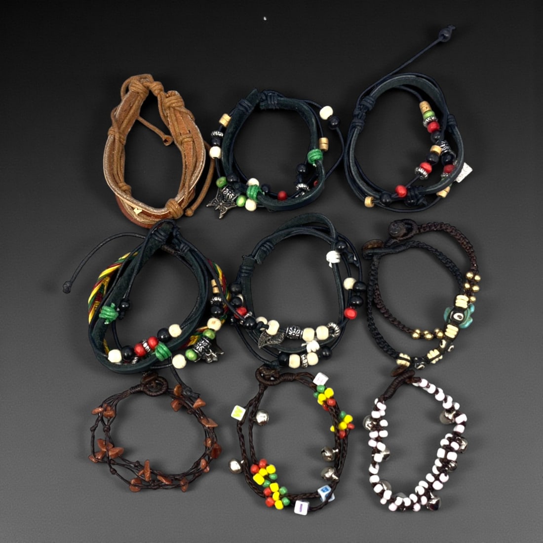 A Group of Eleven Leather and Beaded Bracelets, Late 20th-Early 21st Century, 30ZG: The group comprises eleven bracelets constructed primarily from leather cords combined with assorted beads and minor metal fittings. The designs vary and include braided and wrapped leather elements,