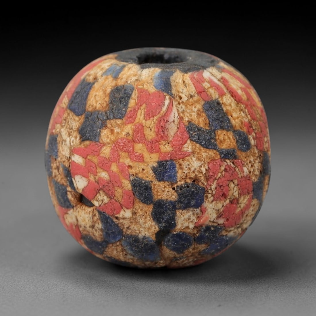 Ancient Glass Mosaic Bead - Roman Bead, 51ZM: This ancient bead is crafted from polychrome mosaic glass, formed using the tesserae technique characteristic of Roman glassworking traditions. The spherical form features a dense pattern of red, blue