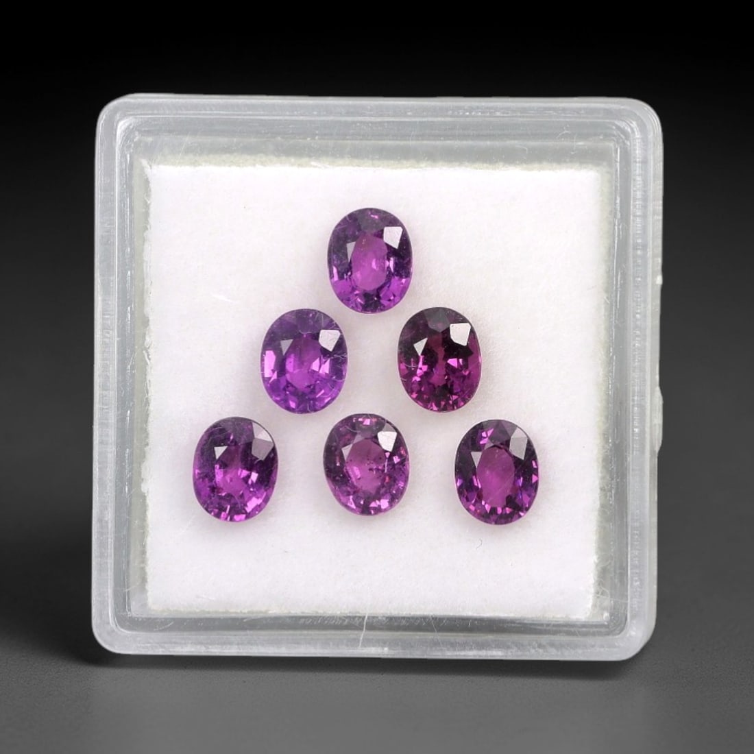 3.08 Carats Oval Mixed-Cut Grape Garnet Parcel - Natural Garnet 5.1x4.2mm, 68XM: This parcel of oval mixed-cut grape garnets showcases a rich, deep purple hue reminiscent of ripe grapes, with subtle pink undertones that lend a luminous, velvety appearance to each stone. The faceti