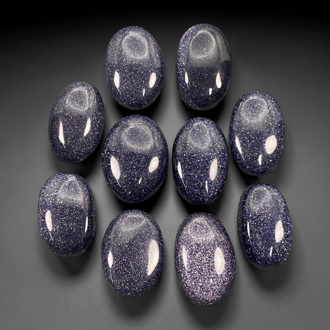 113.72 Carats Midnight Blue Goldstone Oval Cabochon Parcel - 1.7-2cm, 73ZJ: This curated parcel of midnight blue goldstone oval cabochons shimmers with a celestial, star-like sparkle that captures the imagination. Set against a deep, velvety indigo base, each stone is densely