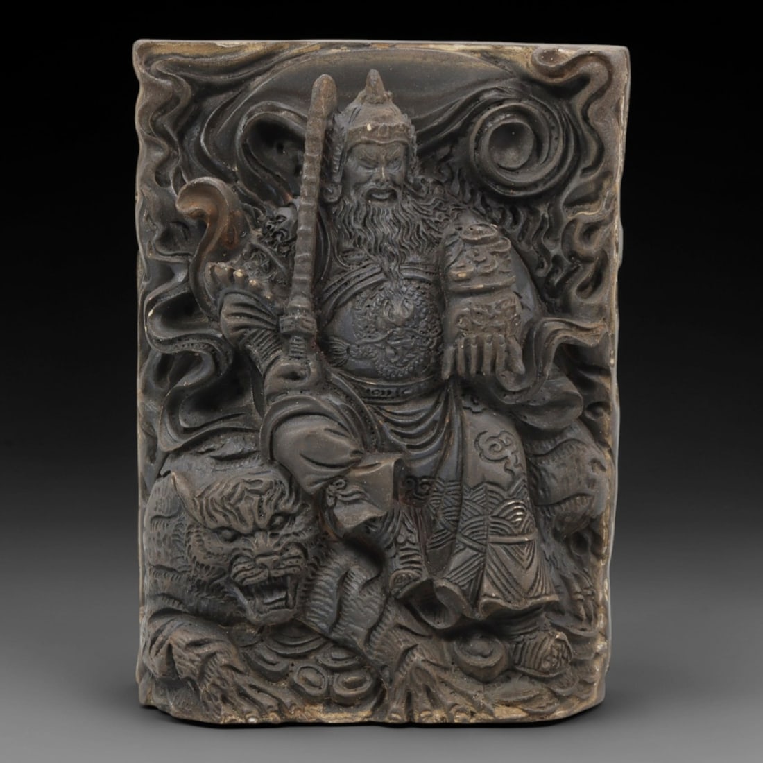 A Chinese Horn or Bone Guandi and Treasure Plaque, 20th Century, 88FV: Carved from horn or bone with a naturally aged, patinated surface and subtle tonal variations, the plaque is rectangular in form, with one side depicting Guandi and the reverse a treasure motif. The f