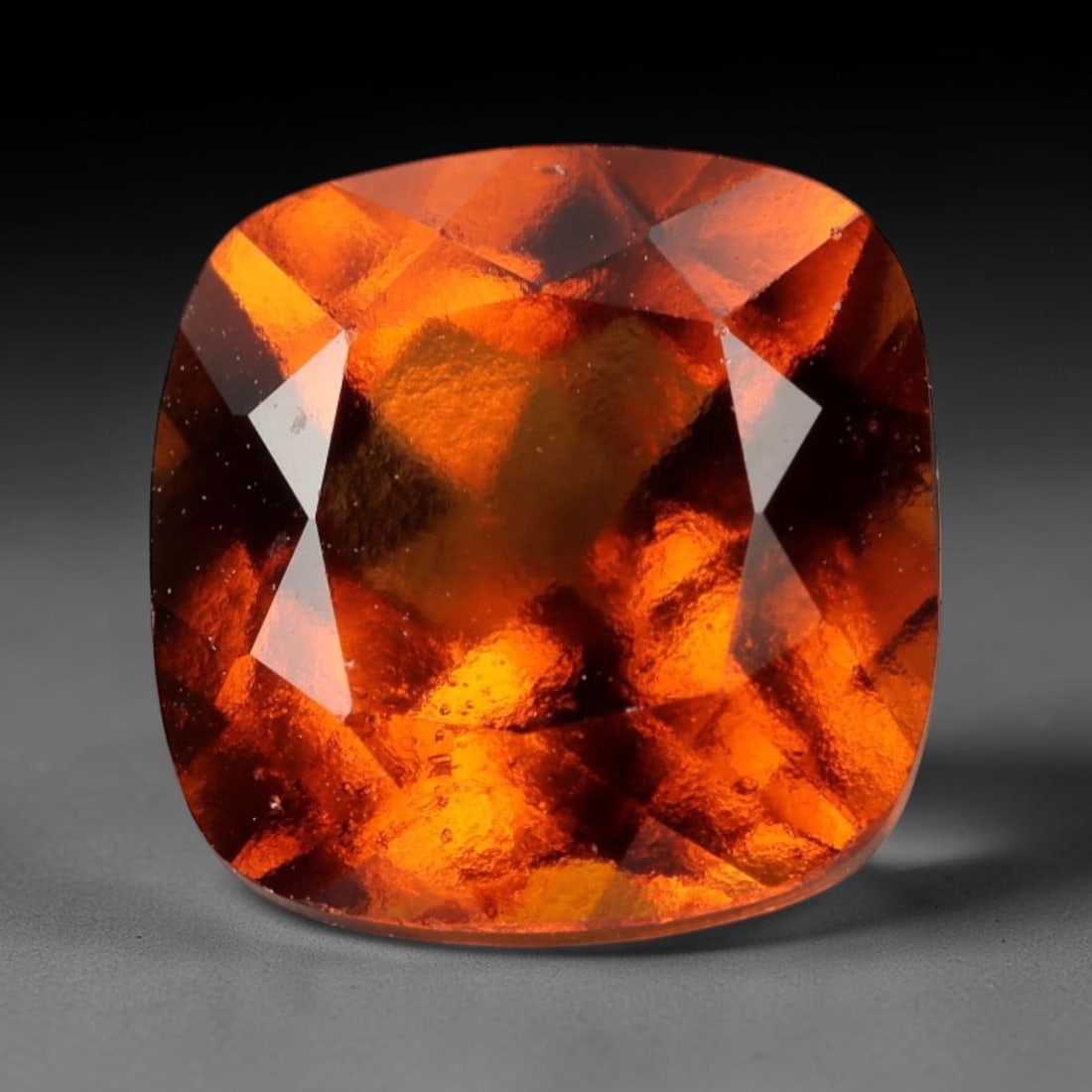 3.230 Carats Orange Hessonite Grossular Garnet - Natural Brazilian Gemstone, LZ273: This substantial cushion fancy-cut hessonite grossular garnet radiates a rich, honeyed orange hue, reminiscent of liquid amber and sun-warmed citrus. The cushion cut's soft, rounded edges and intricat