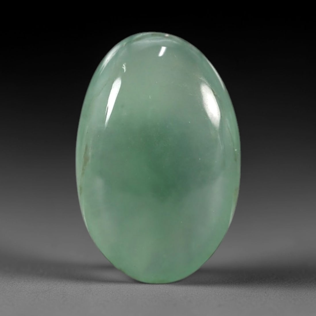 2.27 Carats Apple Green Burmese Jadeite Jade Cabochon - Natural Loose Gemstone, 61XN: This singular Burmese jadeite jade cabochon presents a luminous apple green hue, soft and luminous with a translucent quality that allows light to filter gently through its smooth, domed surface. The