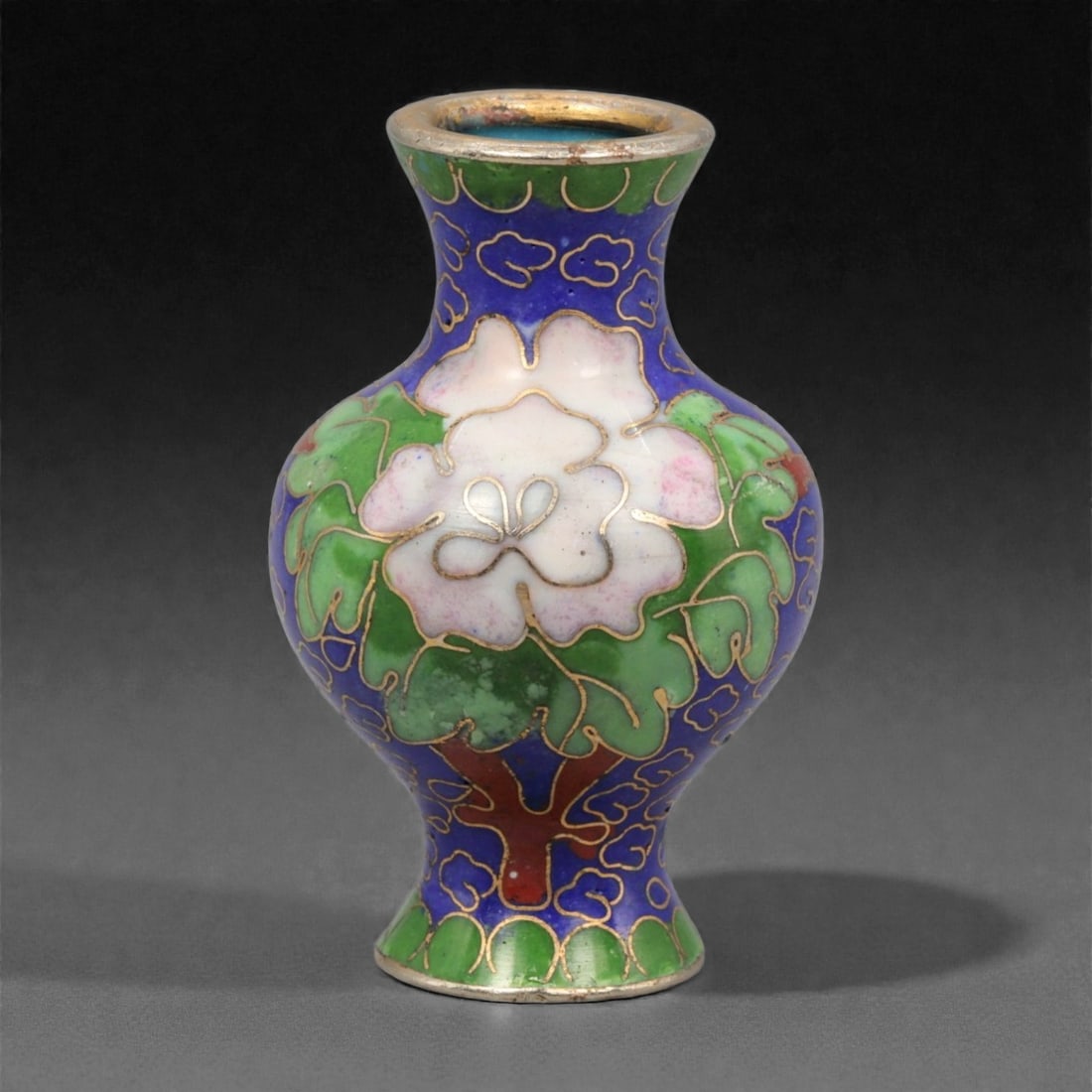 A Chinese Miniature Cloisonne Enamel Vase, 20th Century, 73YC: Constructed in copper and decorated with polychrome cloisonne enamel, the miniature vase is formed with a compressed baluster body rising to a short waisted neck and slightly flared mouth, all finishe
