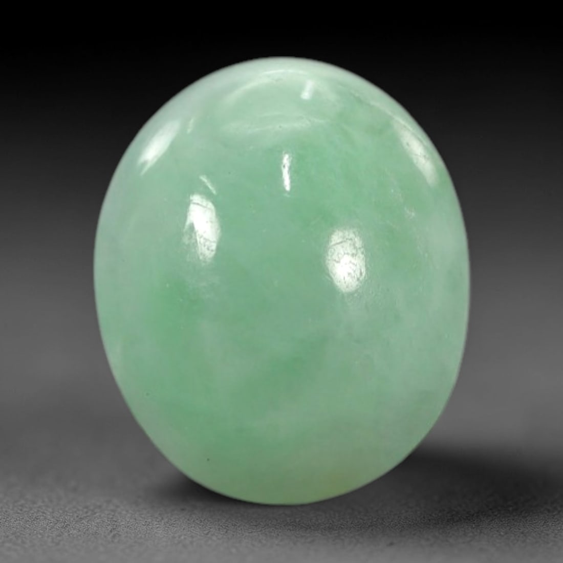 2.85 Carats Apple Green Burmese Jadeite Jade Cabochon - Natural Loose Gemstone, 49XN: This singular Burmese jadeite jade cabochon presents a luminous apple green hue, soft and luminous with a translucent quality that allows light to filter gently through its smooth, domed surface. The