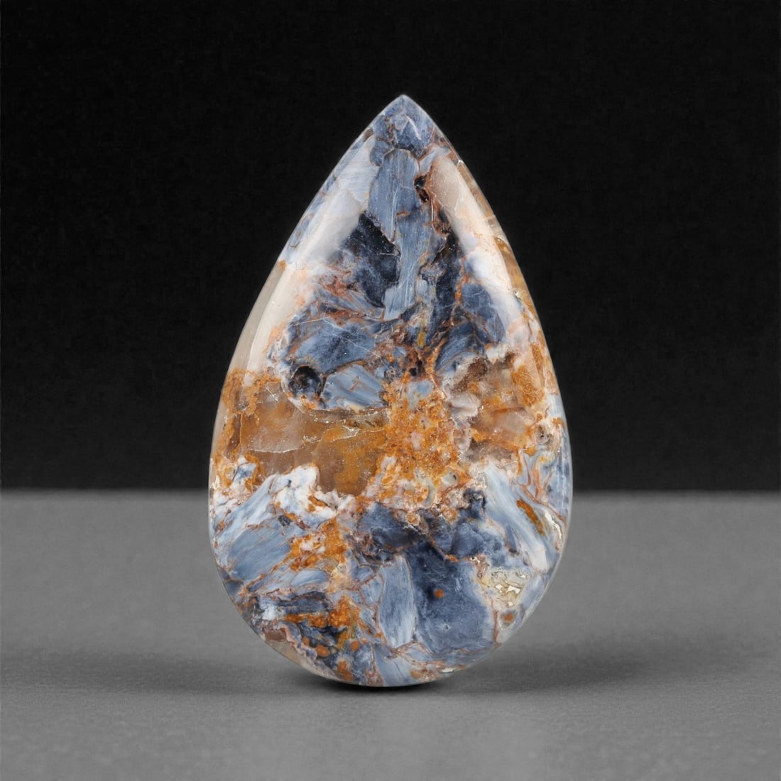 53.65 Carats Sky Blue Pietersite Cabochon - Natural Namibian - 45.7 x 28.1 x 6.1 mm, 22XK: This breathtaking pietersite cabochon radiates with an ethereal blend of sky blue, and stormy gray hues, captured in a sweeping teardrop silhouette. With its intricate natural patterning and shimmerin