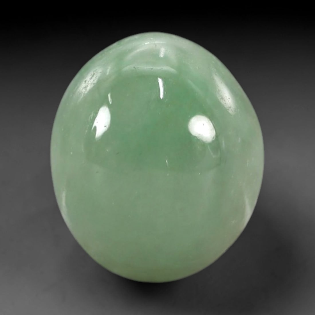 4.82 Carats Apple Green Burmese Jadeite Jade Cabochon - Natural Loose Gemstone, 58XN: This singular Burmese jadeite jade cabochon presents a luminous apple green hue, soft and luminous with a translucent quality that allows light to filter gently through its smooth, domed surface. The