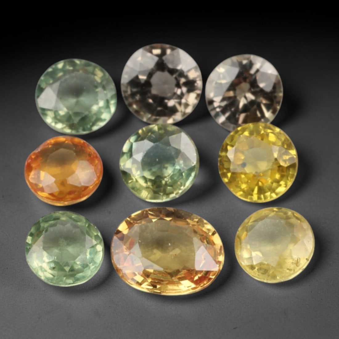 2.34 Carats Fancy Color Sapphire Selection - Natural Loose Gemstones, 94XN: This curated selection of nine faceted sapphires, weighing a total of 2.34 carats with individual dimensions ranging from 3.4 to 4.9 mm, showcases a vibrant spectrum of fancy colors. From cool mint gr