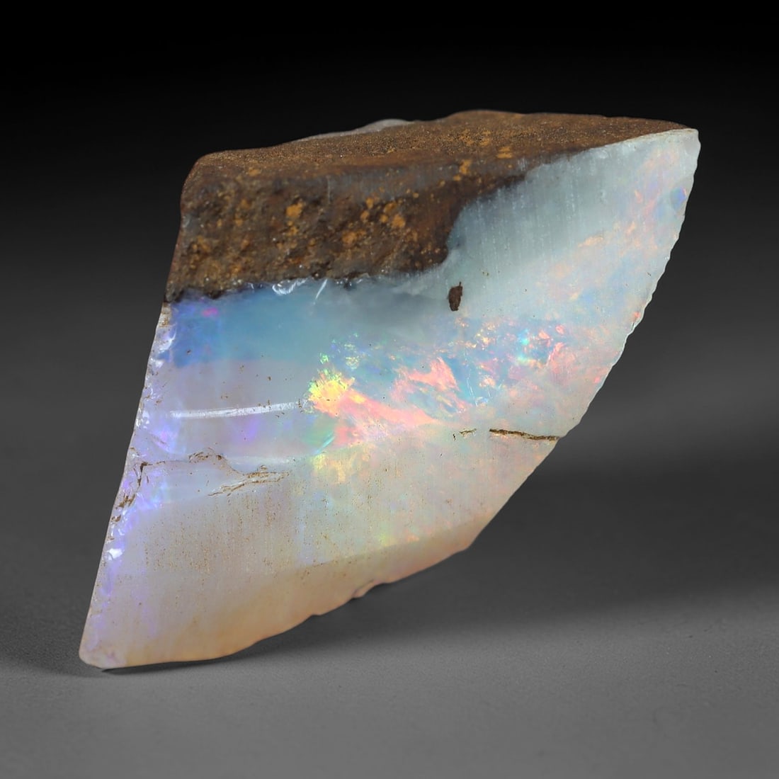 4.93ct Winton Boulder Opal Rough - Natural Play-of-Color Specimen, 31XM: This 4.93ct rough boulder opal, measuring 20x11mm, is a striking example of Winton, Queensland's iconic gemstone, showcasing the raw beauty of nature's artistry. The specimen retains its natural irons